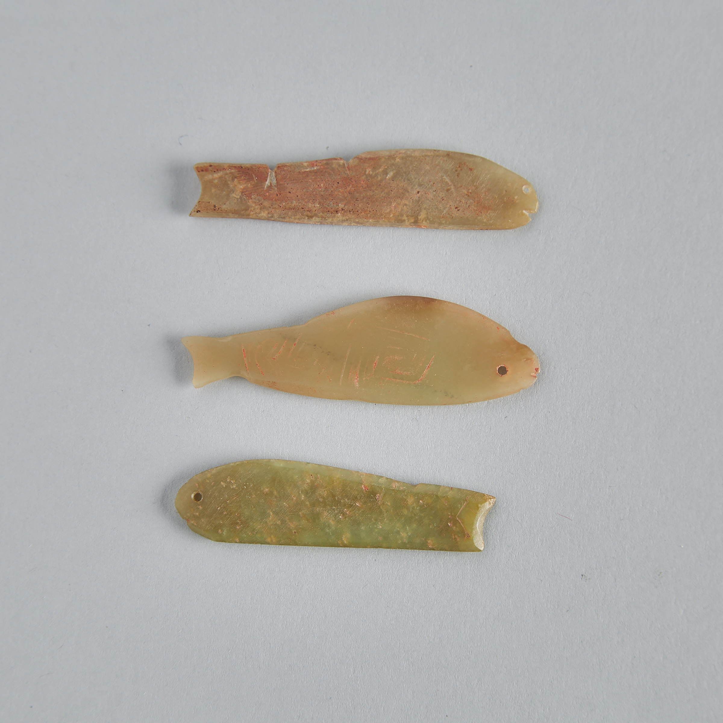 A Group of Three Chinese Jade Fish Form Amulet Pendants, Neolithic Period