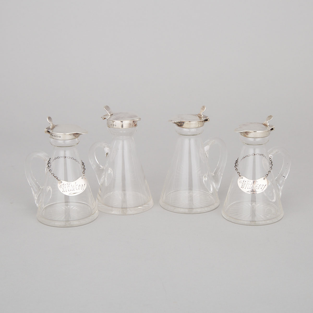Four English Silver Mounted Cut Glass Whiskey Tots with Two Labels, London and Birmingham, 1922/30