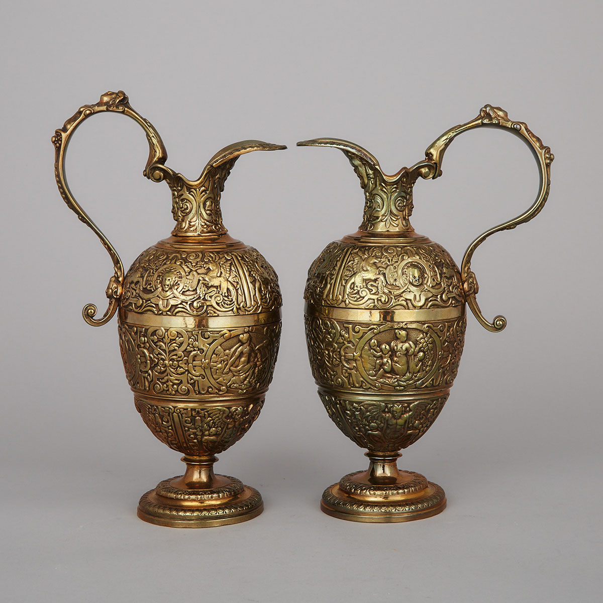 Pair of Continental Gilt Bronze Cellini Jugs, mid 20th century