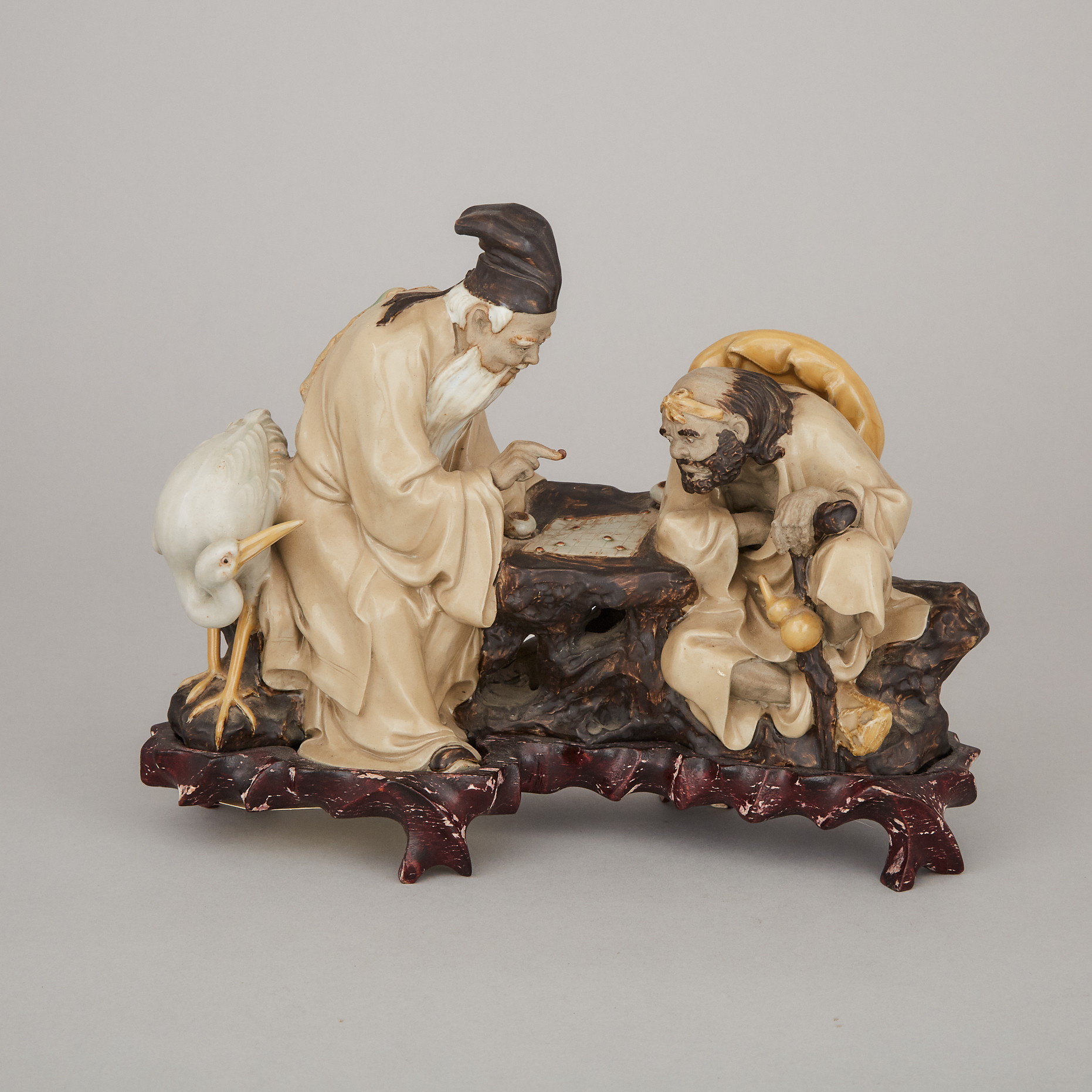 A Shiwan Stoneware Sculpture of Two Figures Playing Weiqi