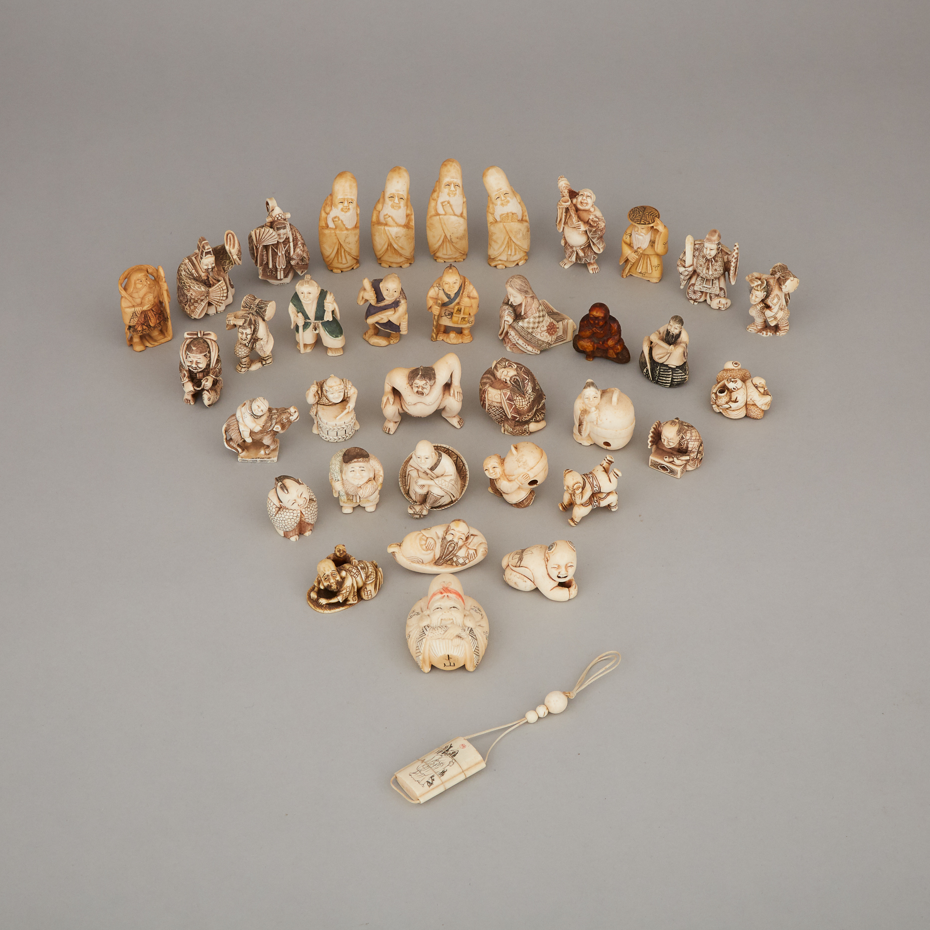 A Group of Thirty-Six Ivory and Ivorine Carved Netsuke, Circa 1940