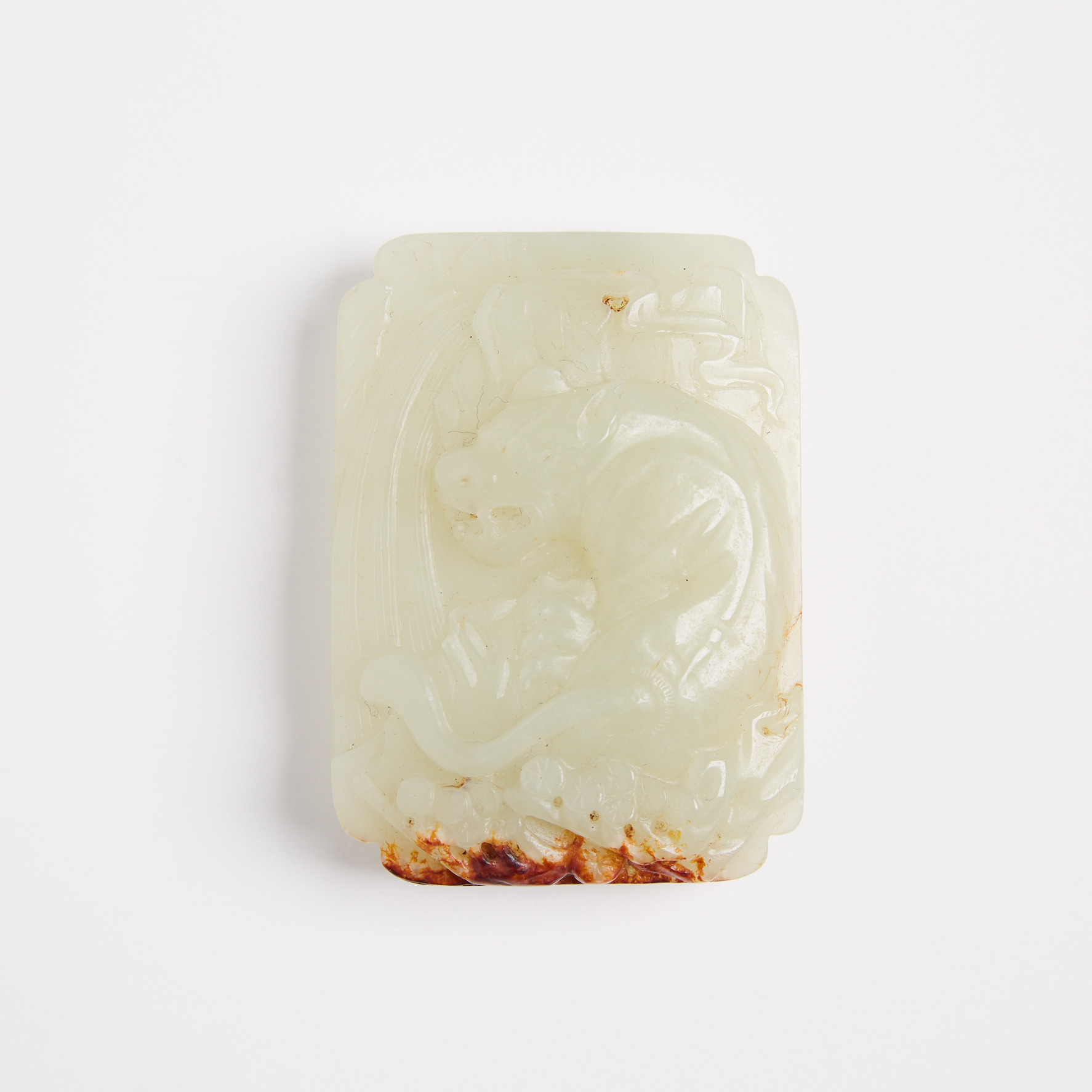 A Celadon and Russet Jade Carved Belt Buckle, Yuan/Ming Dynasty