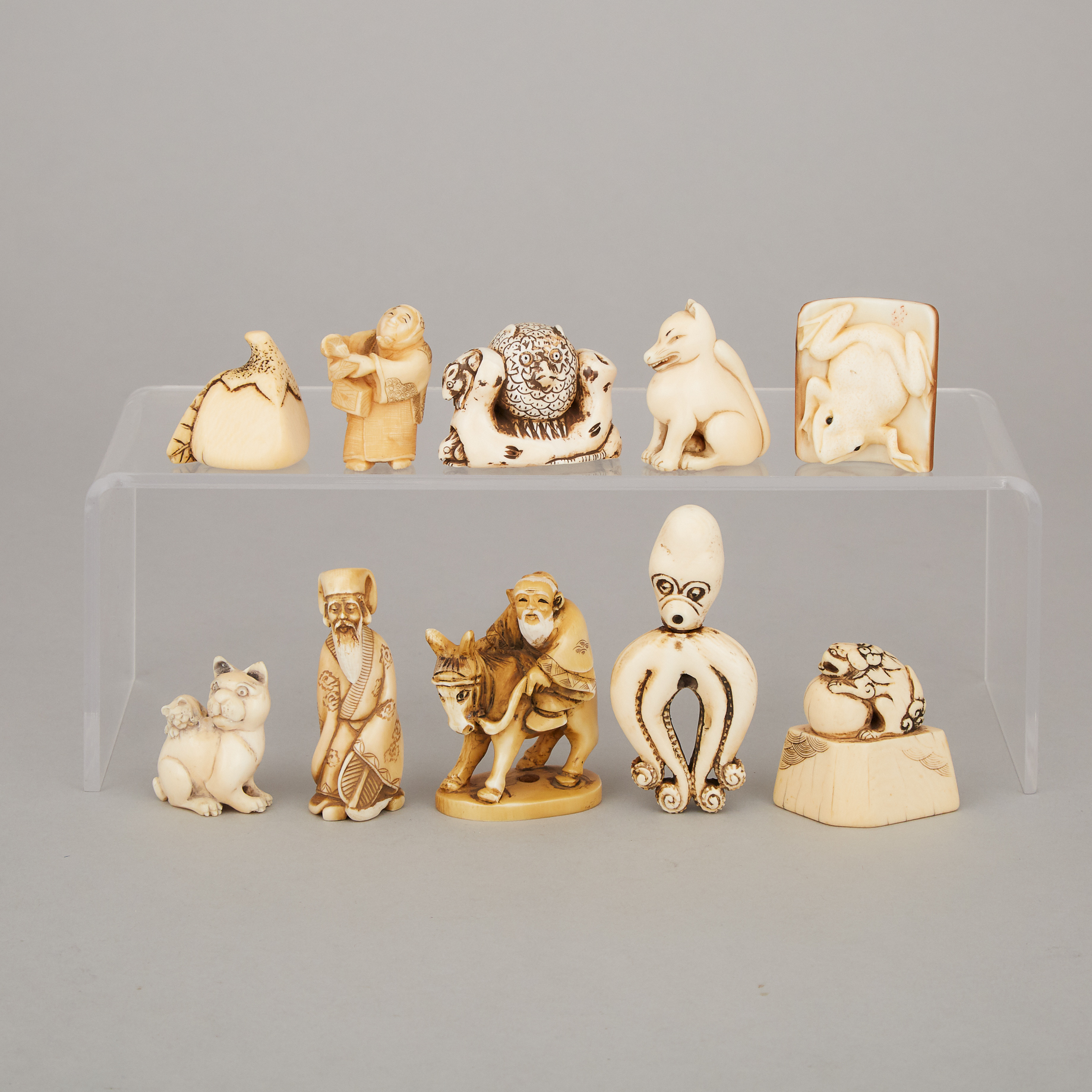 A Group of Ten Ivory and Ivorine Carved Netsukes