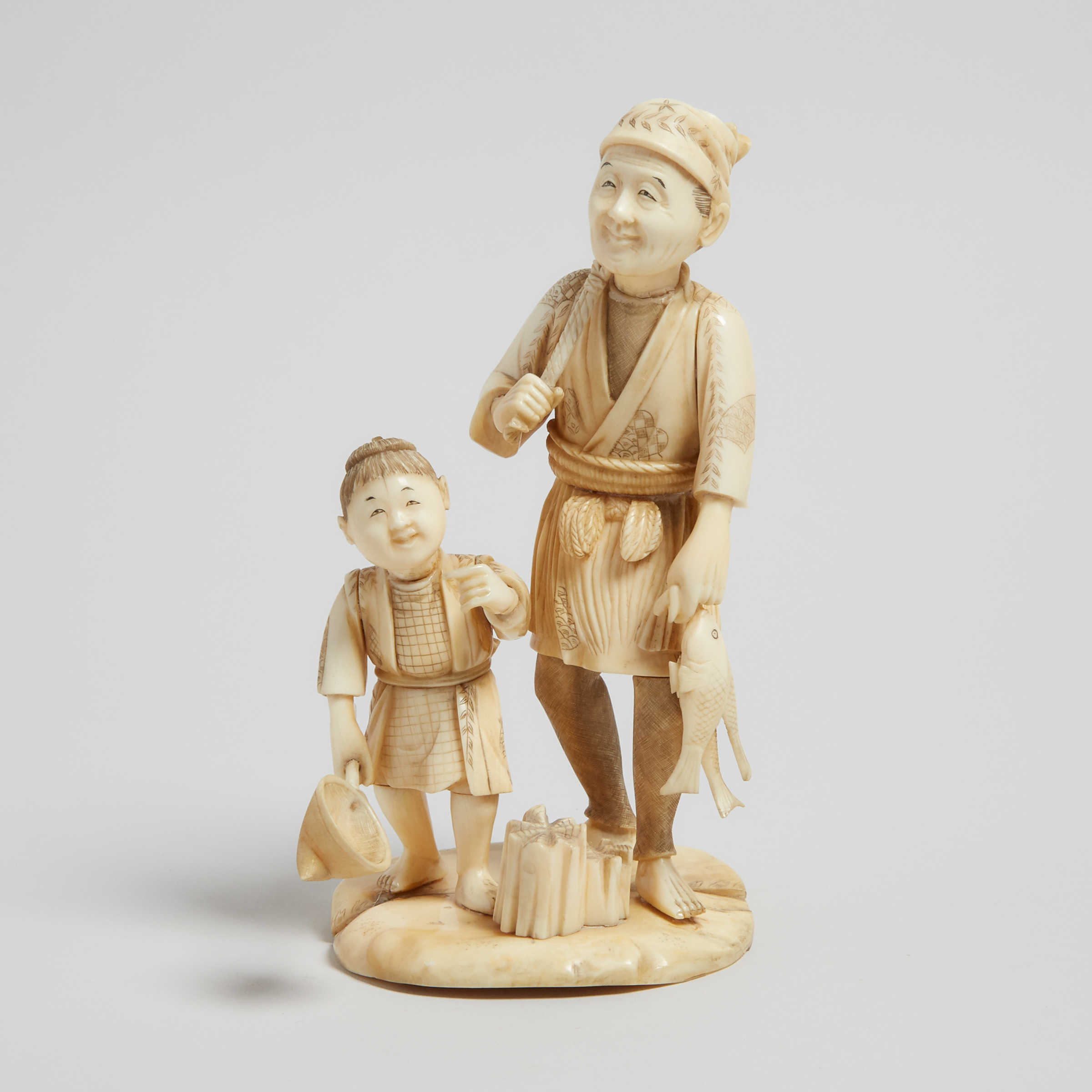 A Bone Carved Okimono of a Fisherman and Child, Early 20th Century