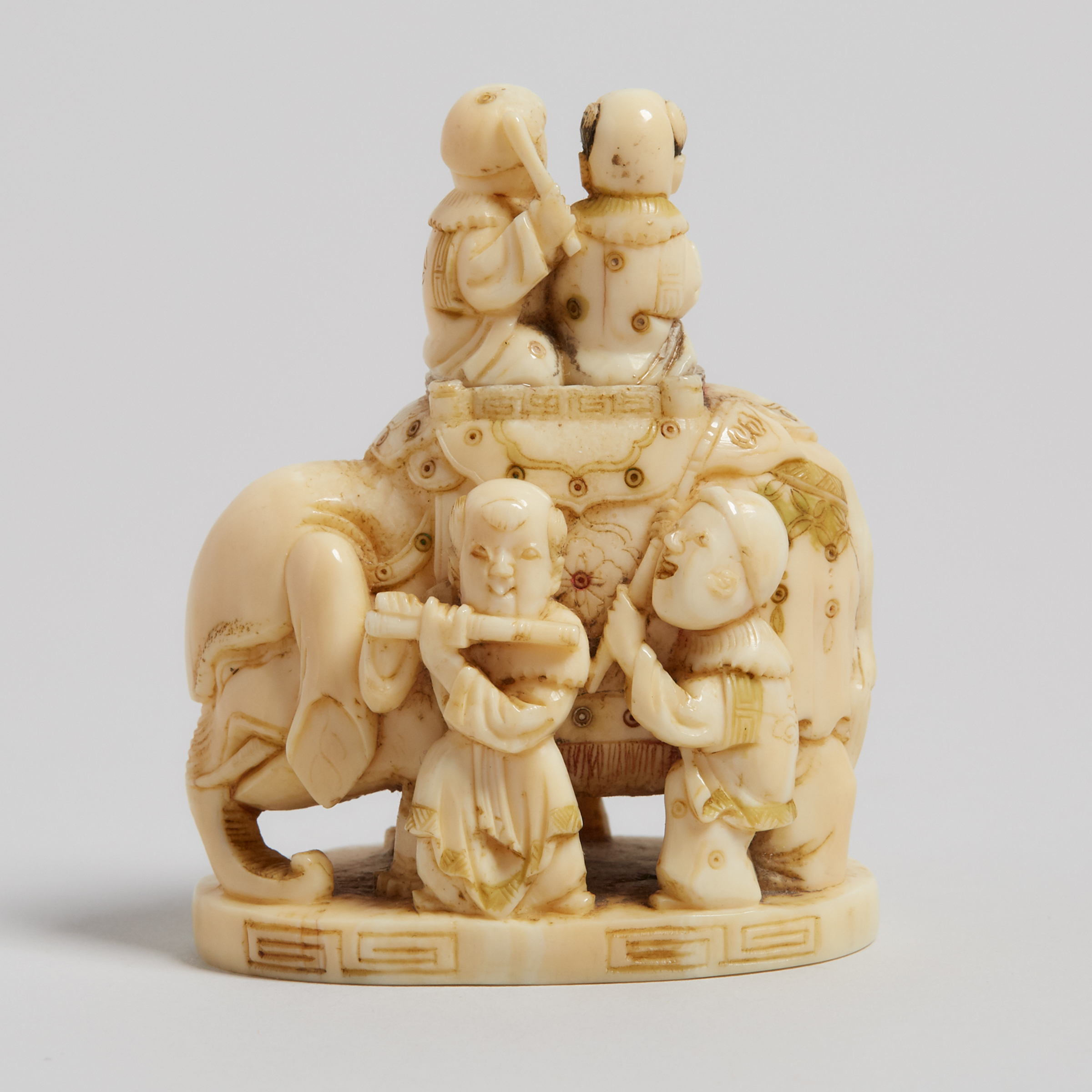 An Ivory Carved 'Elephant and Karako' Group Okimono, 19th Century