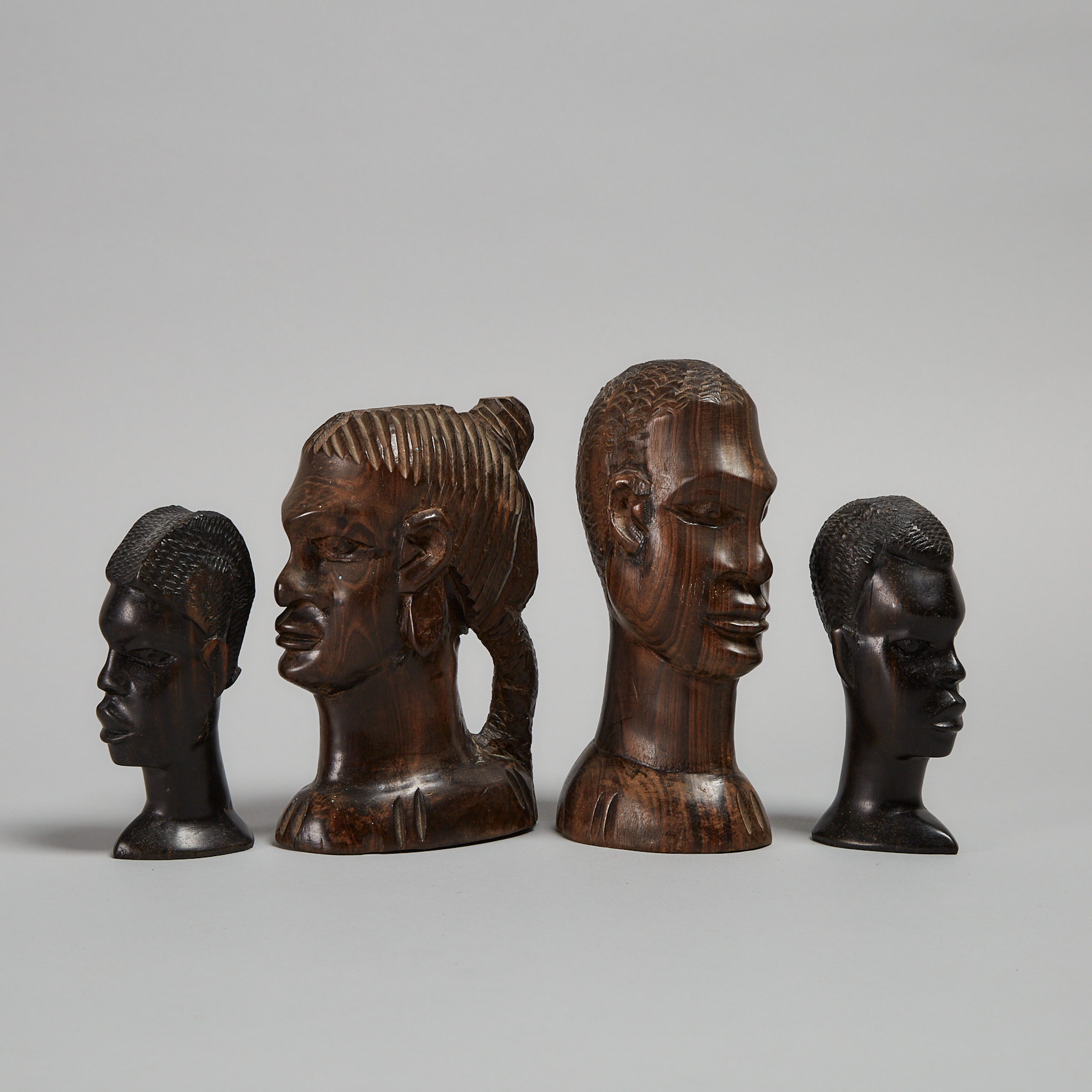 Group of Four Carved Ebony Busts, East Africa
