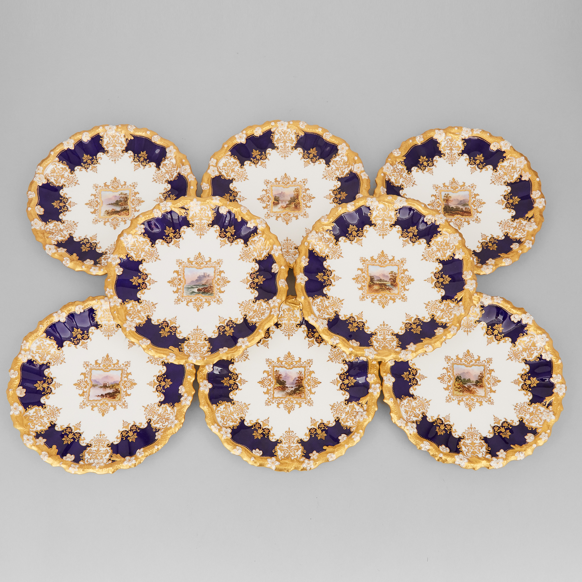 Eight Coalport Blue and Gilt Topographical Plates, early 20th century