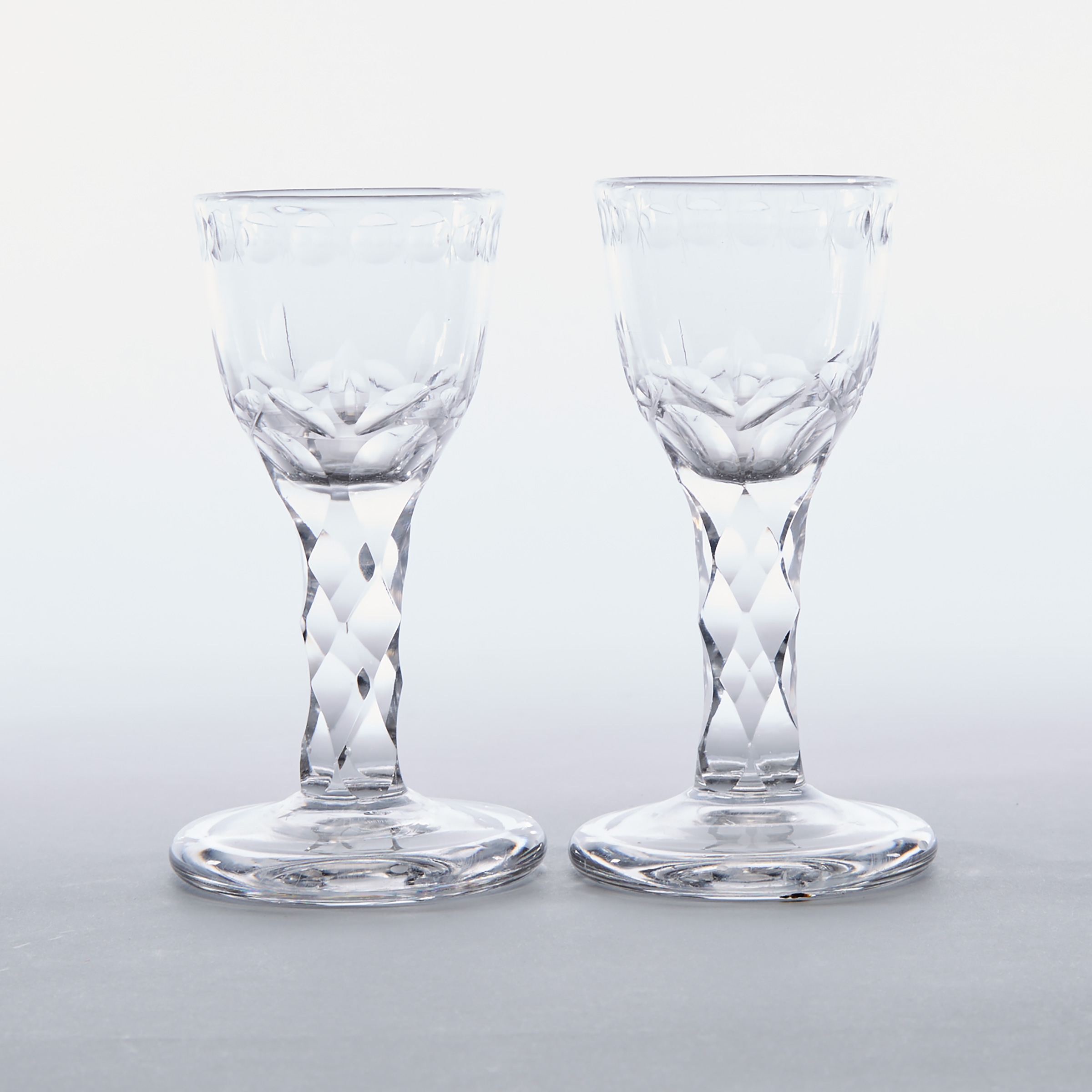 Pair of English Cut and Engraved Faceted Stemmed Dram Glasses, late 18th century
