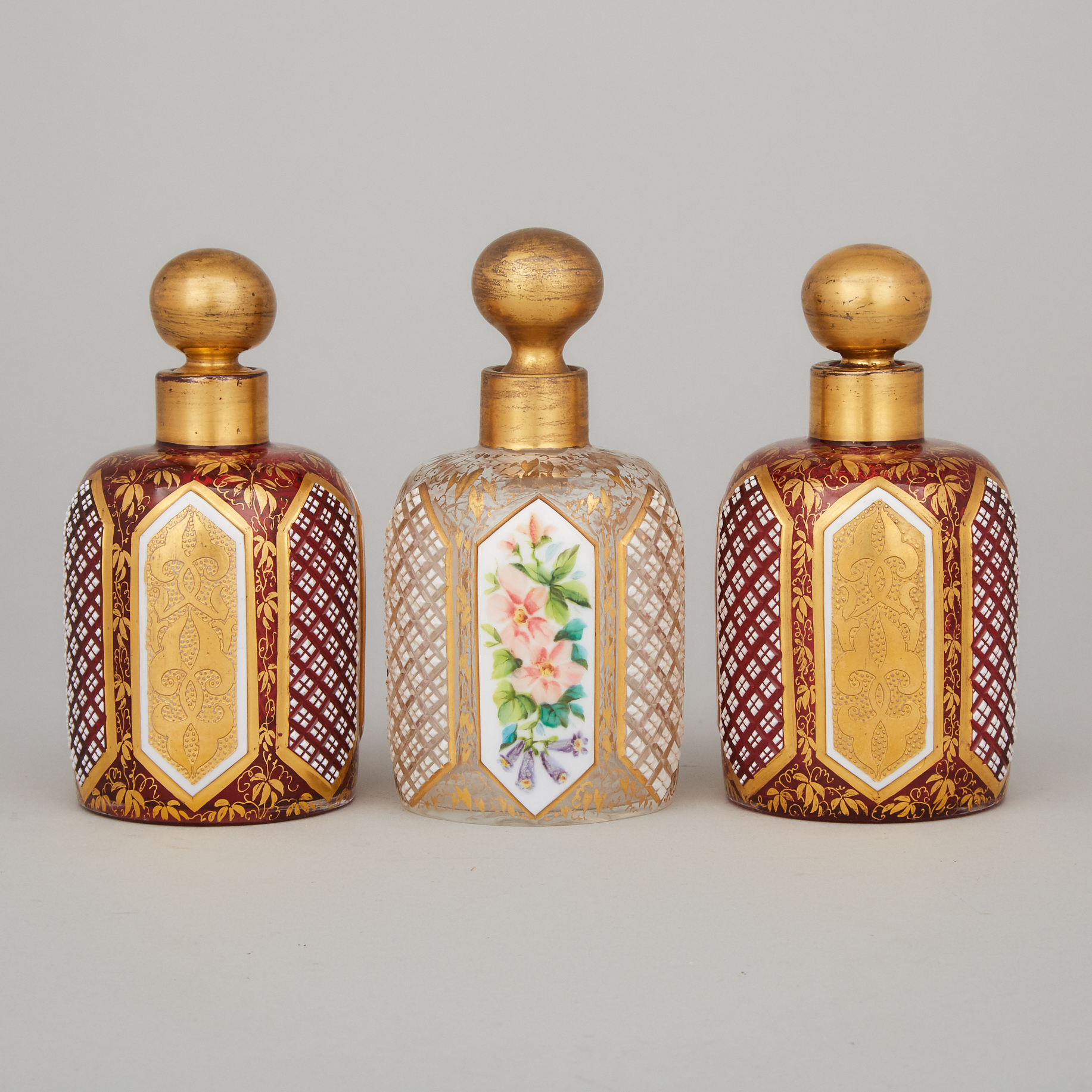 Three Bohemian Overlaid, Enameled and Gilt Glass Perfume Bottles, late 19th century