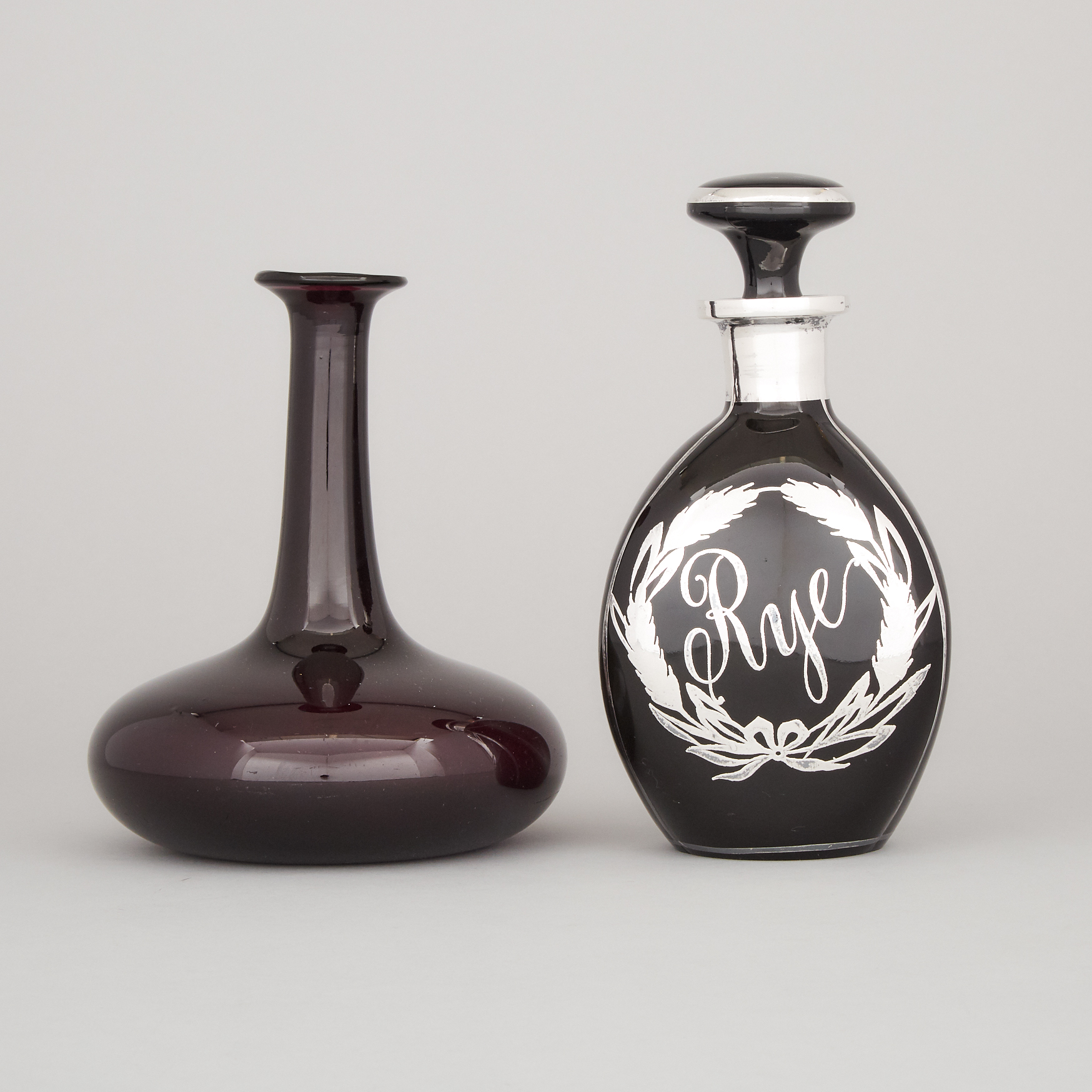 Silver Overlaid Amethyst Glass 'Rye' Decanter and a Carafe, 20th century