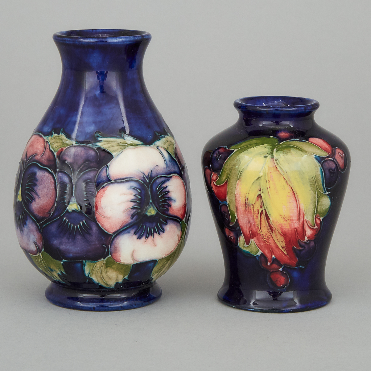 Moorcroft Pansy Vase and a Grape and Leaf Small Vase, 1930s