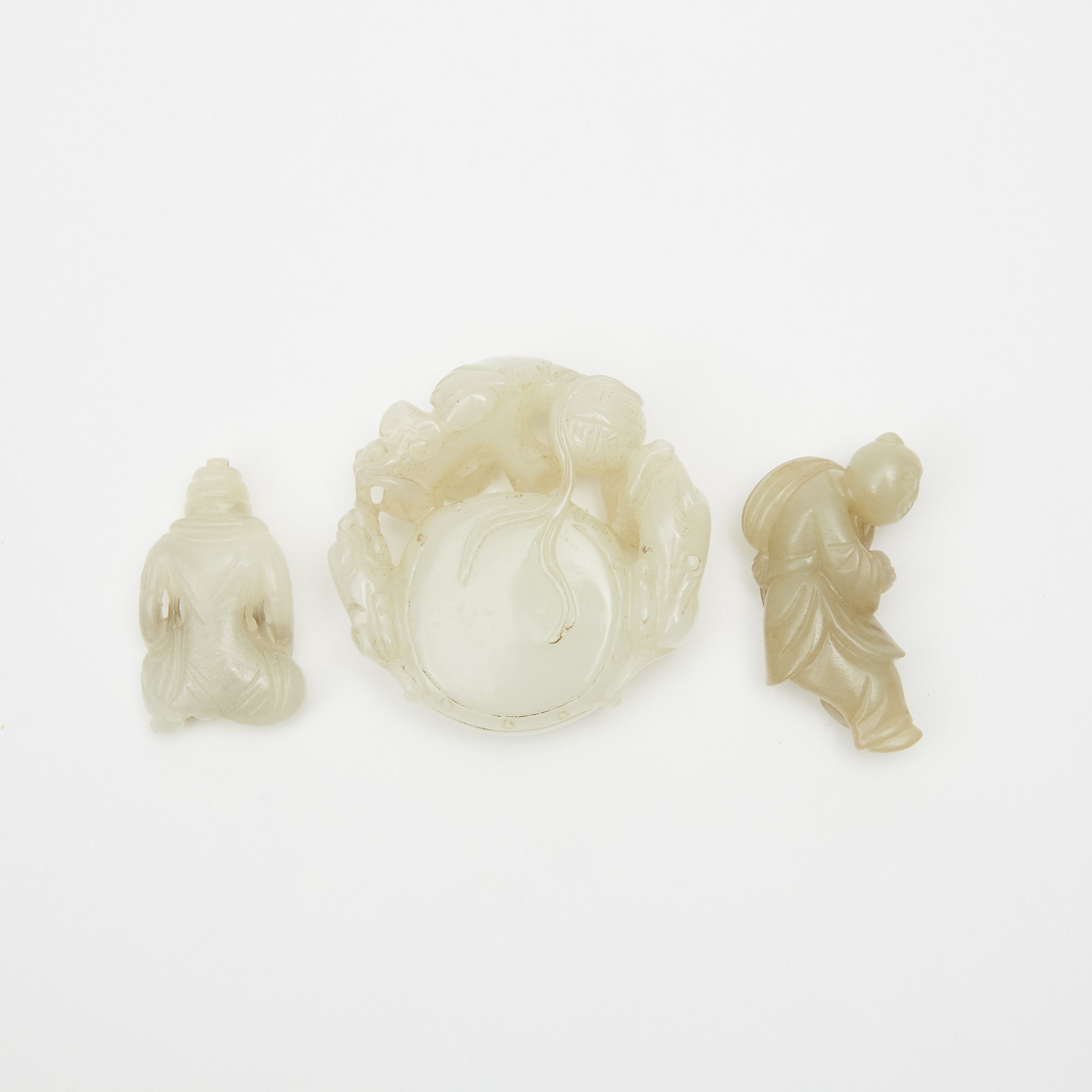 A White Jade Carved 'Immortal Boy' Group and Two Jade Carved Figures