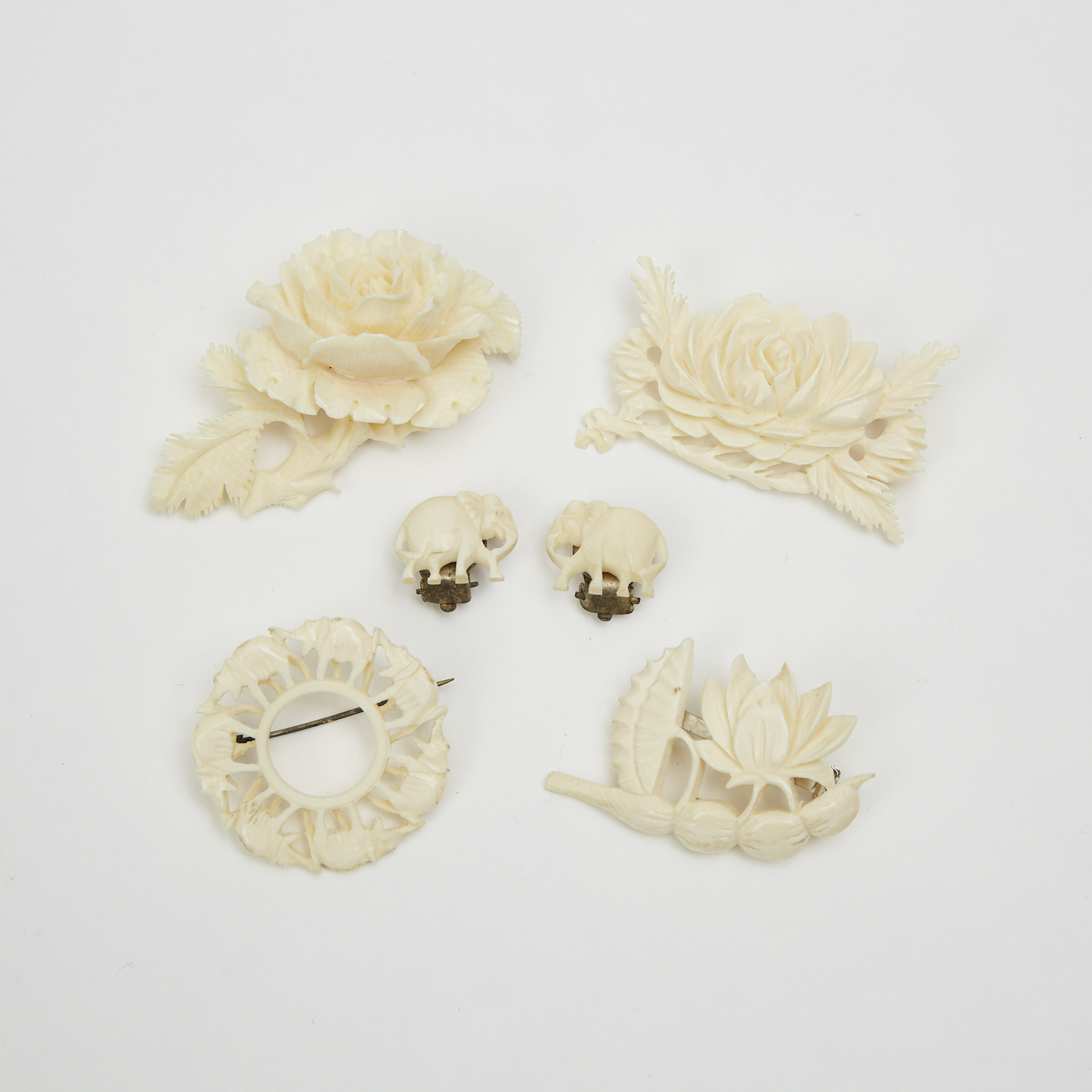A Group of Four Ivory Brooches and a Pair of Clip-Back Earrings