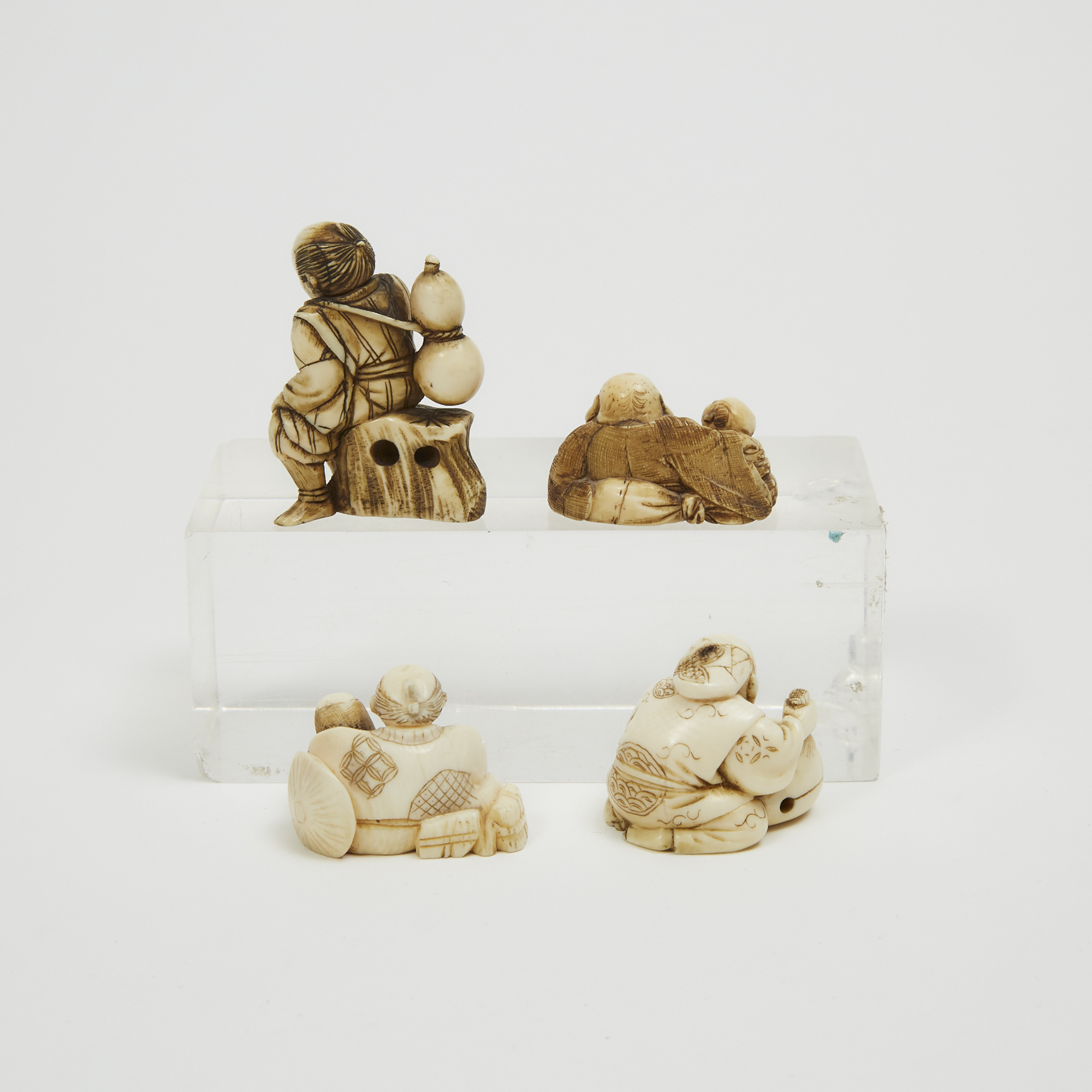 A Group of Four Ivory Figural Netsuke, Late 19th/Early 20th Century