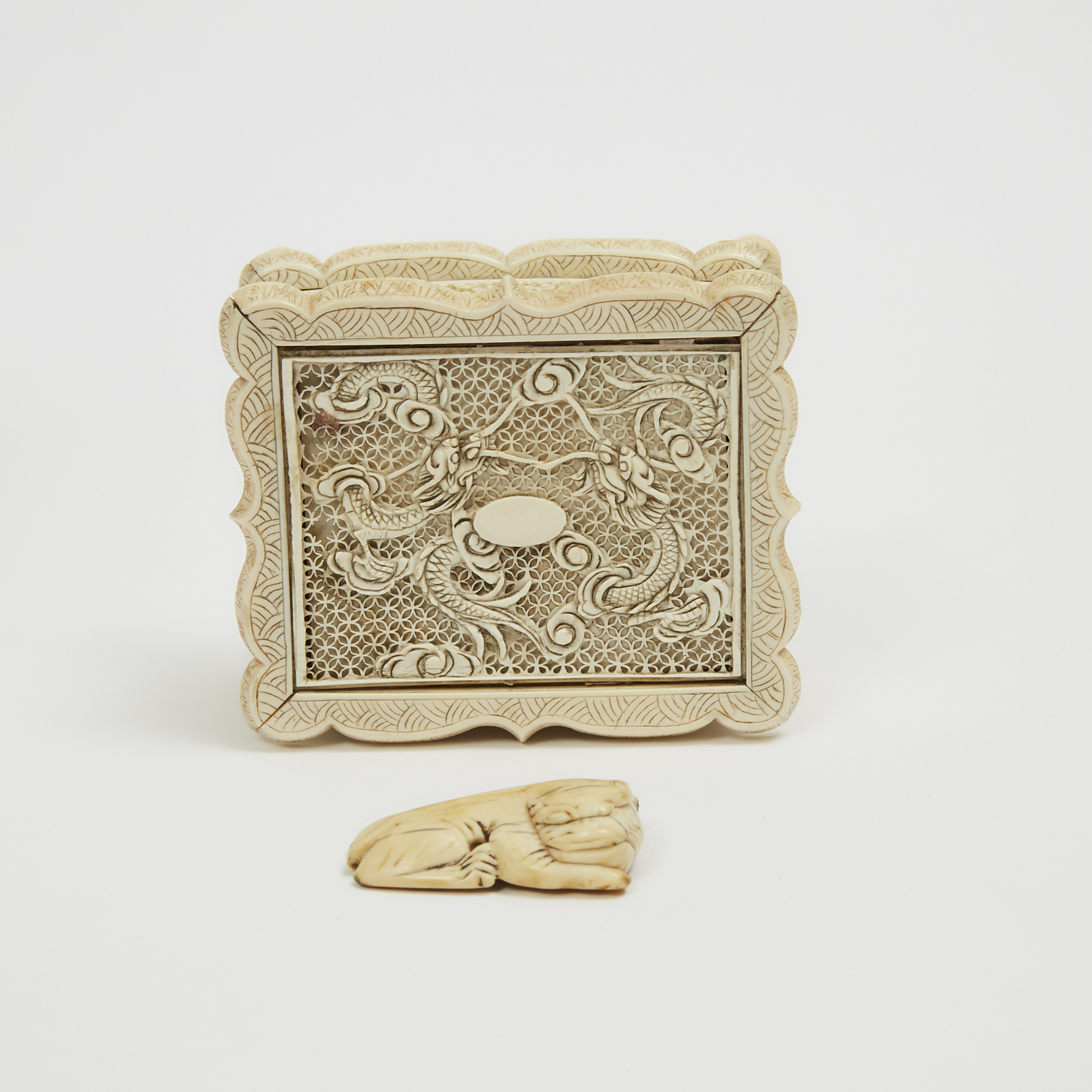 A Chinese Ivory Puzzle Ball, Jewellery Box, and Toggle, 19th/Early 20th Century