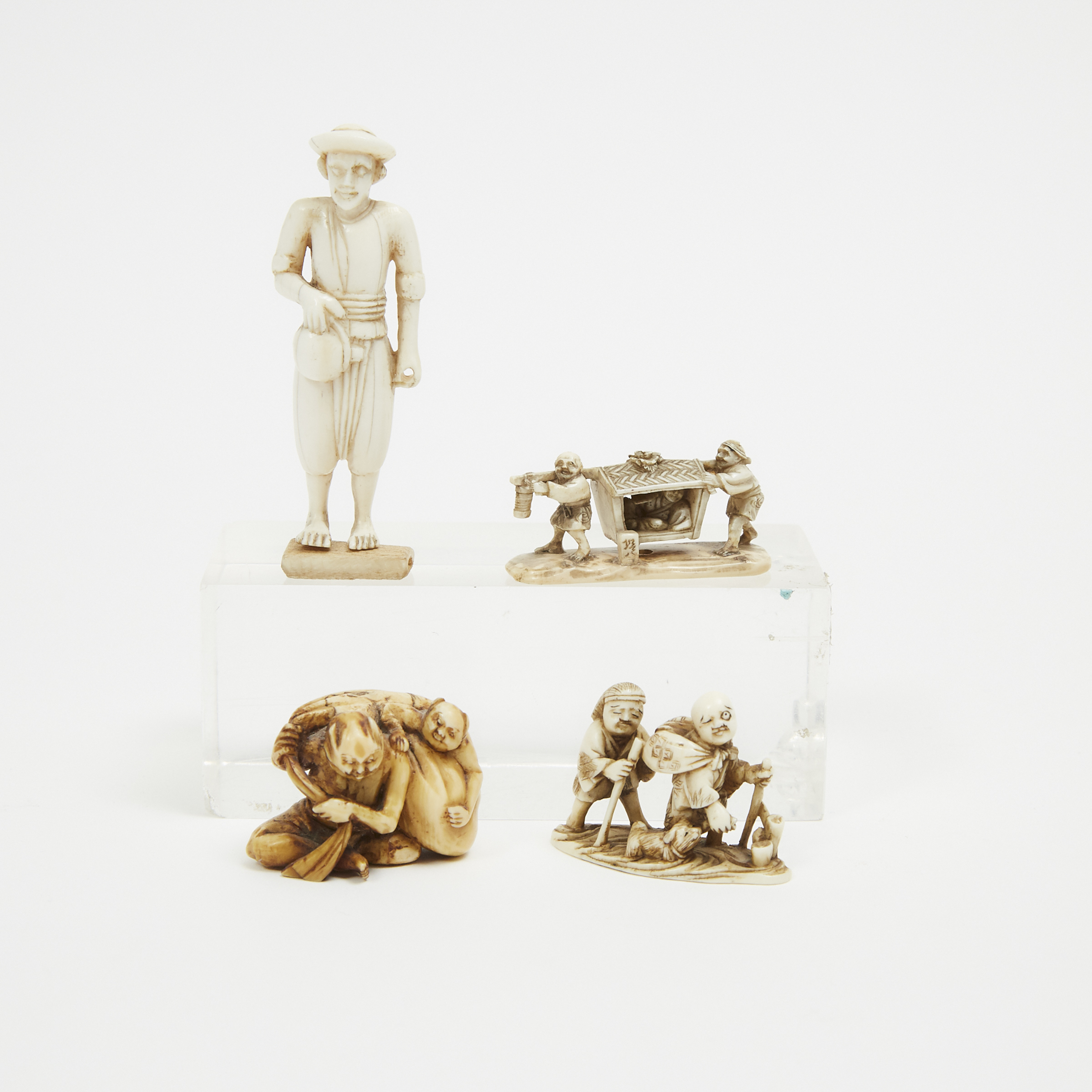 A Group of Four Ivory Carved Figural Netsuke, 19th Century and Later