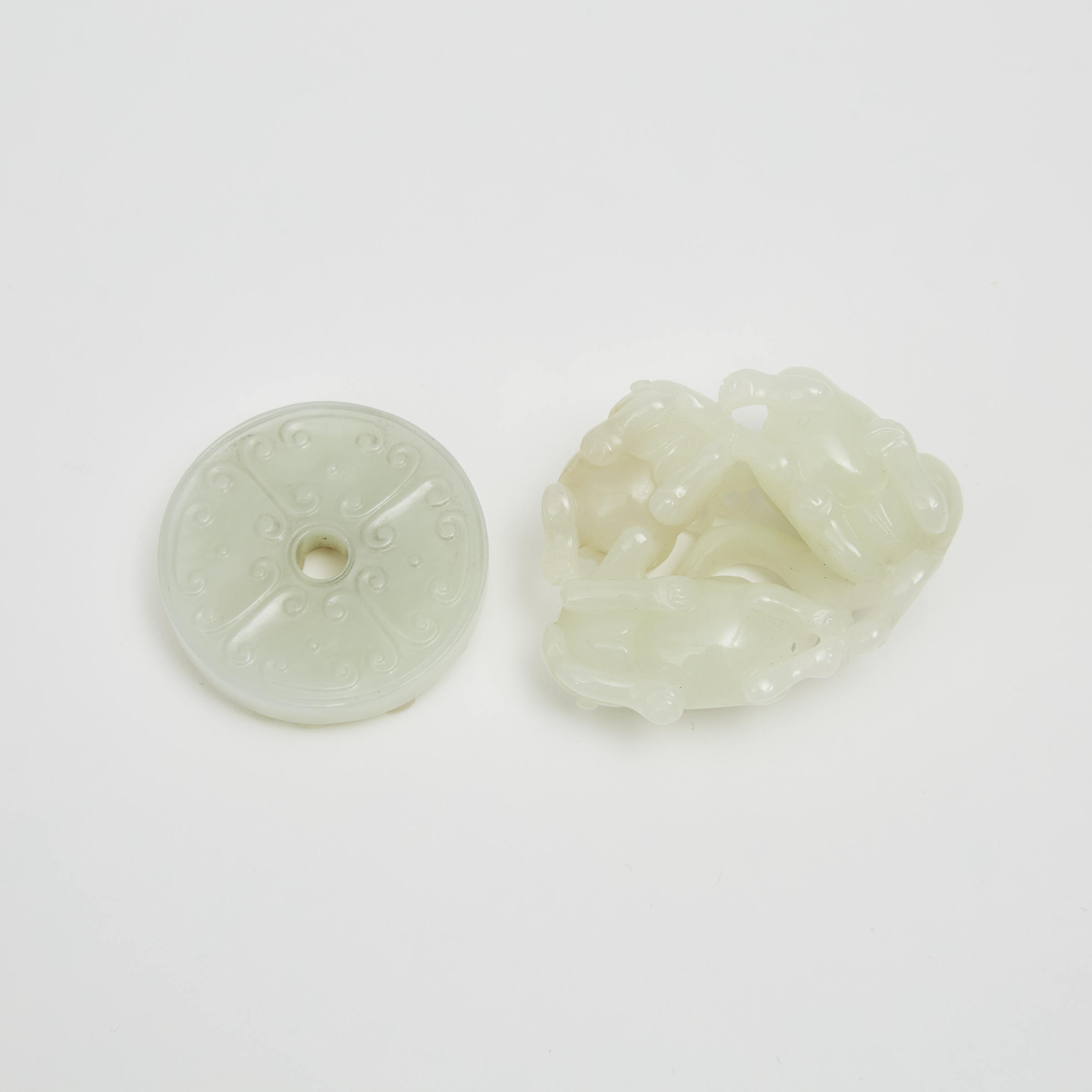 A White Jade 'Cats' Group and a Pale Celadon Jade and Russet 'Chi-Dragon' Bi Disc