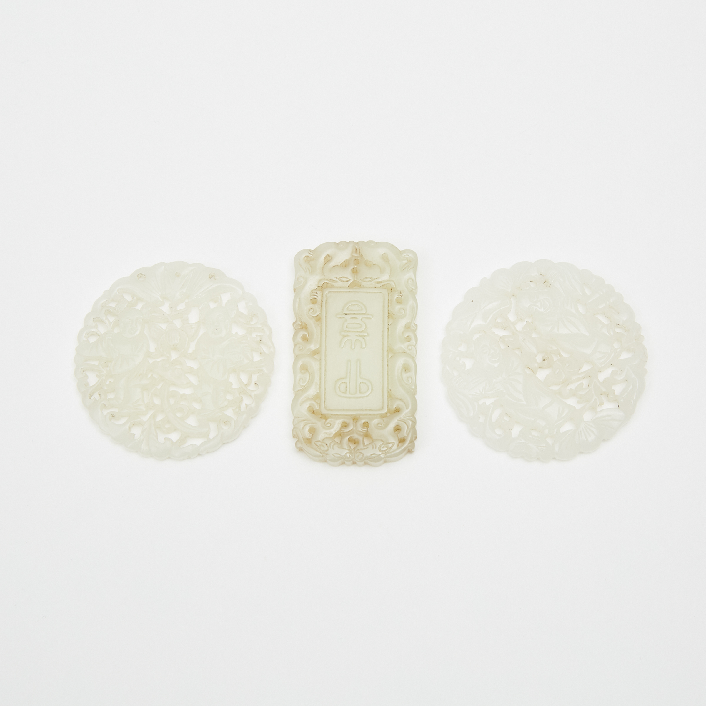 Two White Jade Openwork Plaques and a Yellow Jade Rectangular Pendant