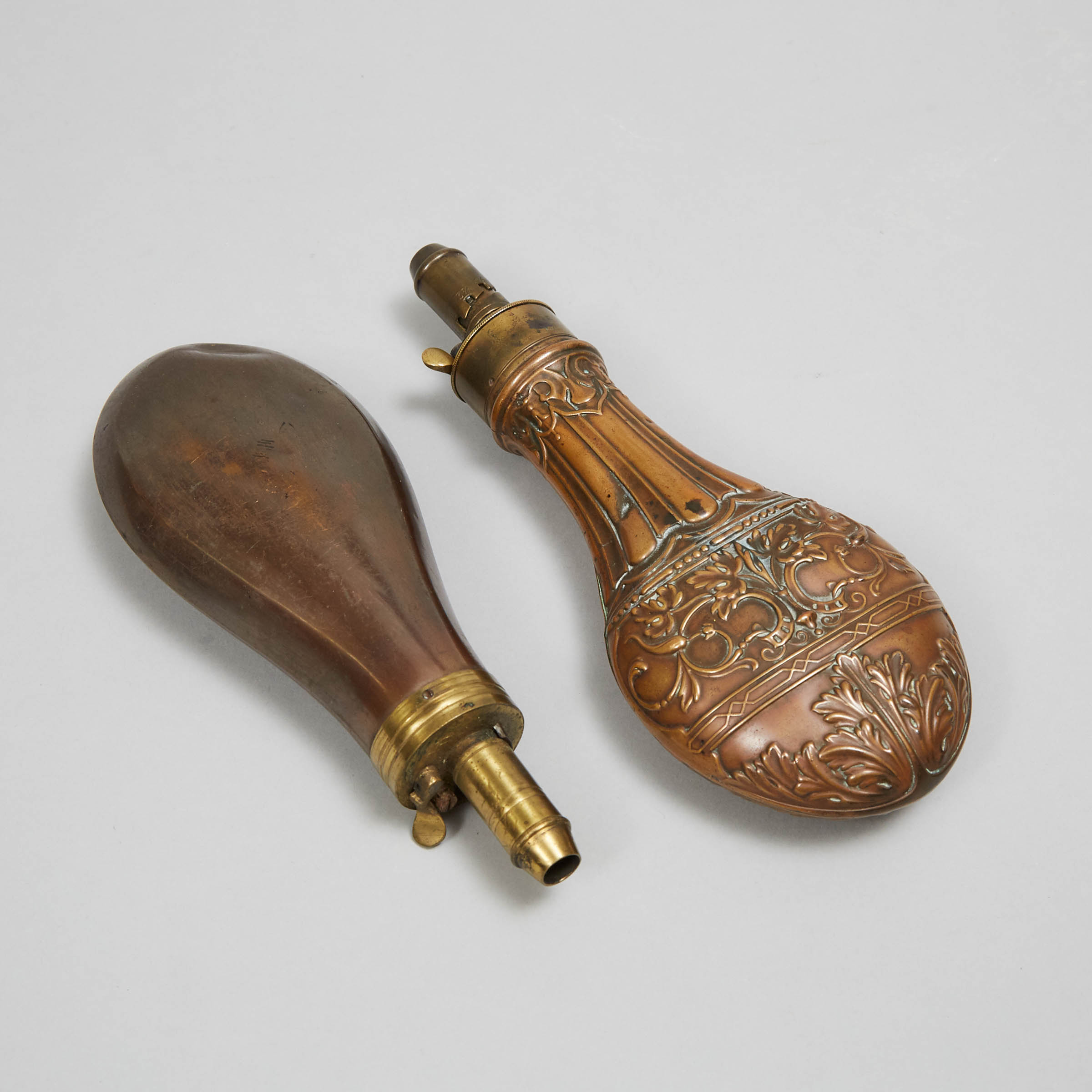 Two Victorian Copper Powder Flasks, 19th century