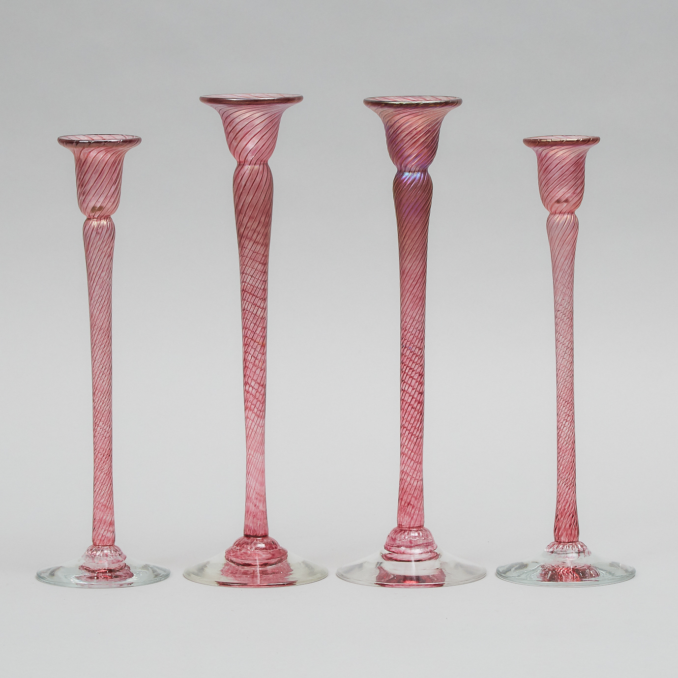 Four Robert Held (American-Canadian, b.1943), Iridescent Pink Glass Candlesticks, 20th century