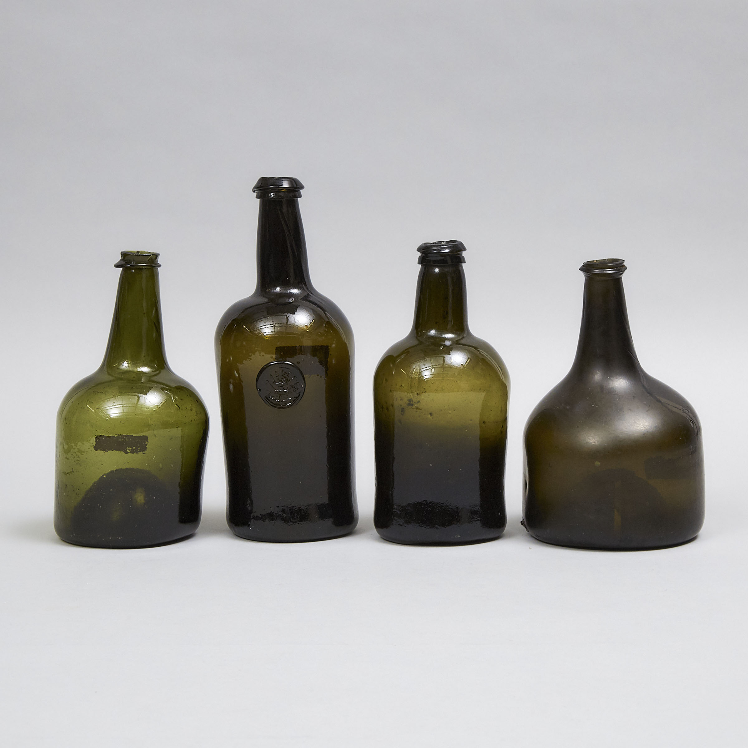 English Green Glass Applied Seal Wine Bottle with Crest and Three Others, 18th/early 19th century