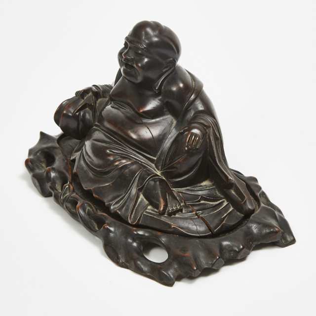 A Hardwood Carved Reclining Laughing Buddha with Stand