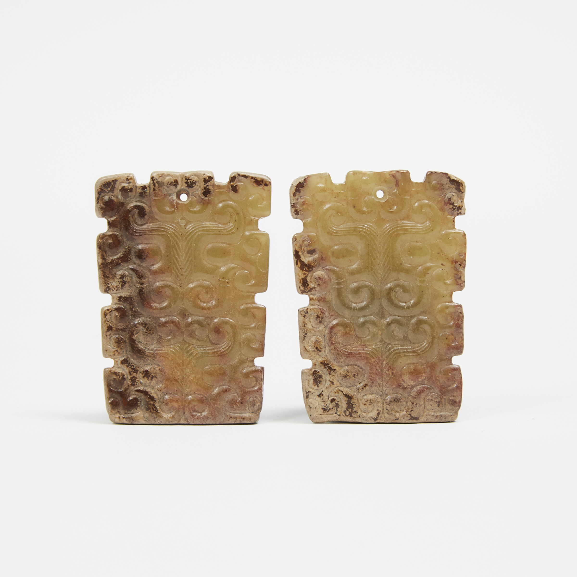 Two Archaic-Style Celadon and Russet Stone Carved Pendants with Taotie Mask Designs
