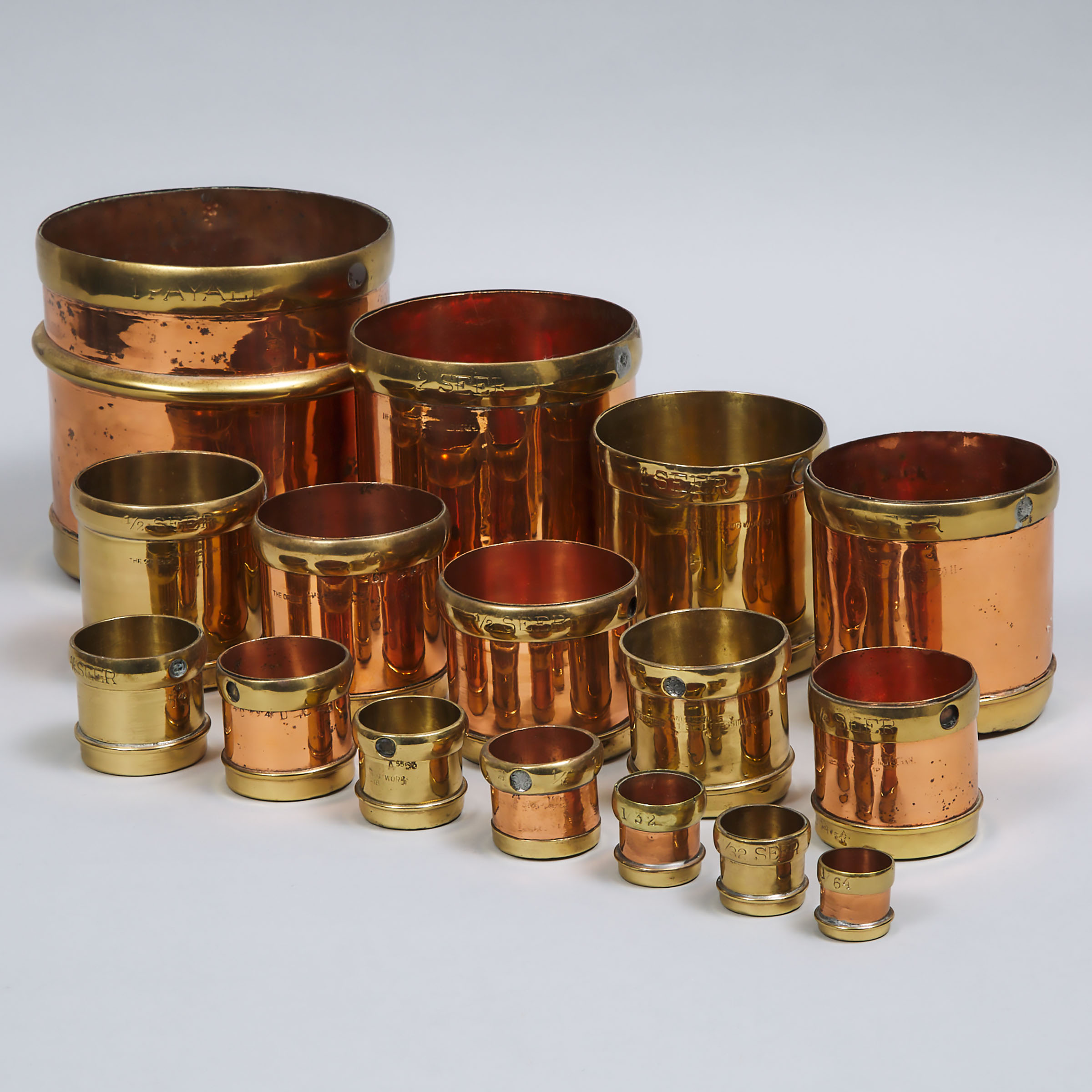 Two Graduated Sets of Copper and Brass Seer Measures,  The Oriental Pressing Works, Bombay, India, 19th/early 20th century