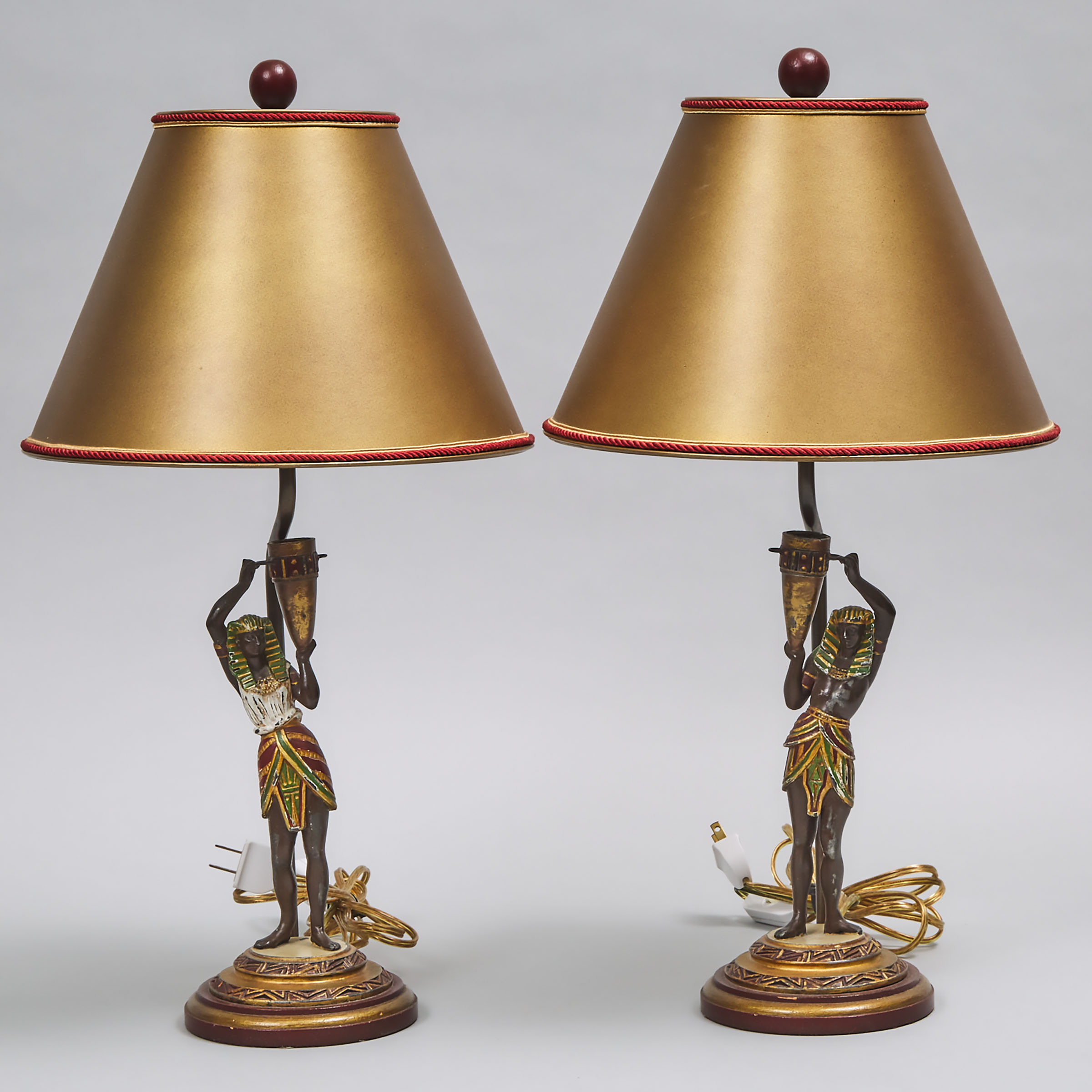 Pair of Cold Painted Metal Egyptian Revival Figural Candlestick Lamps, early 20th century