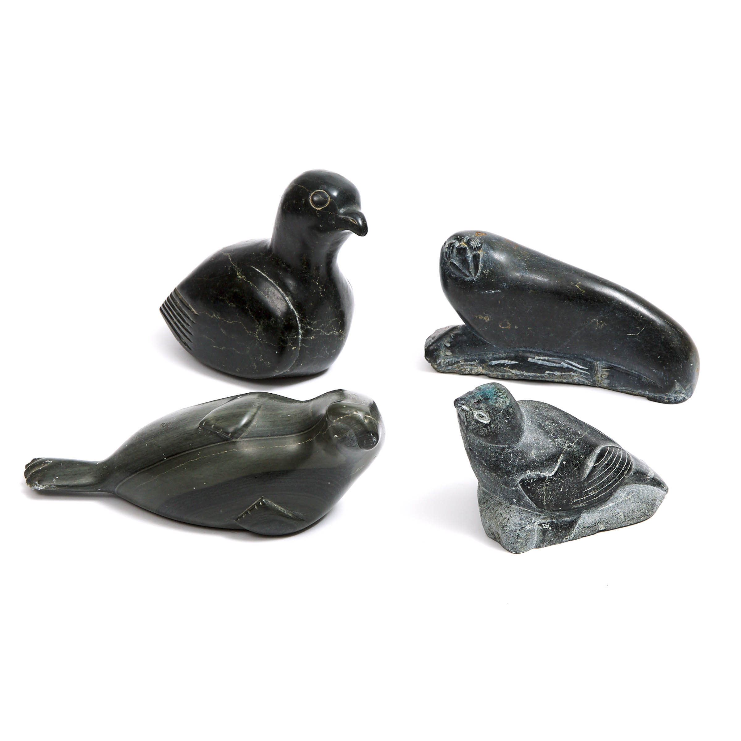 A COLLECTION OF INUIT CARVINGS OF BIRDS AND SEALS