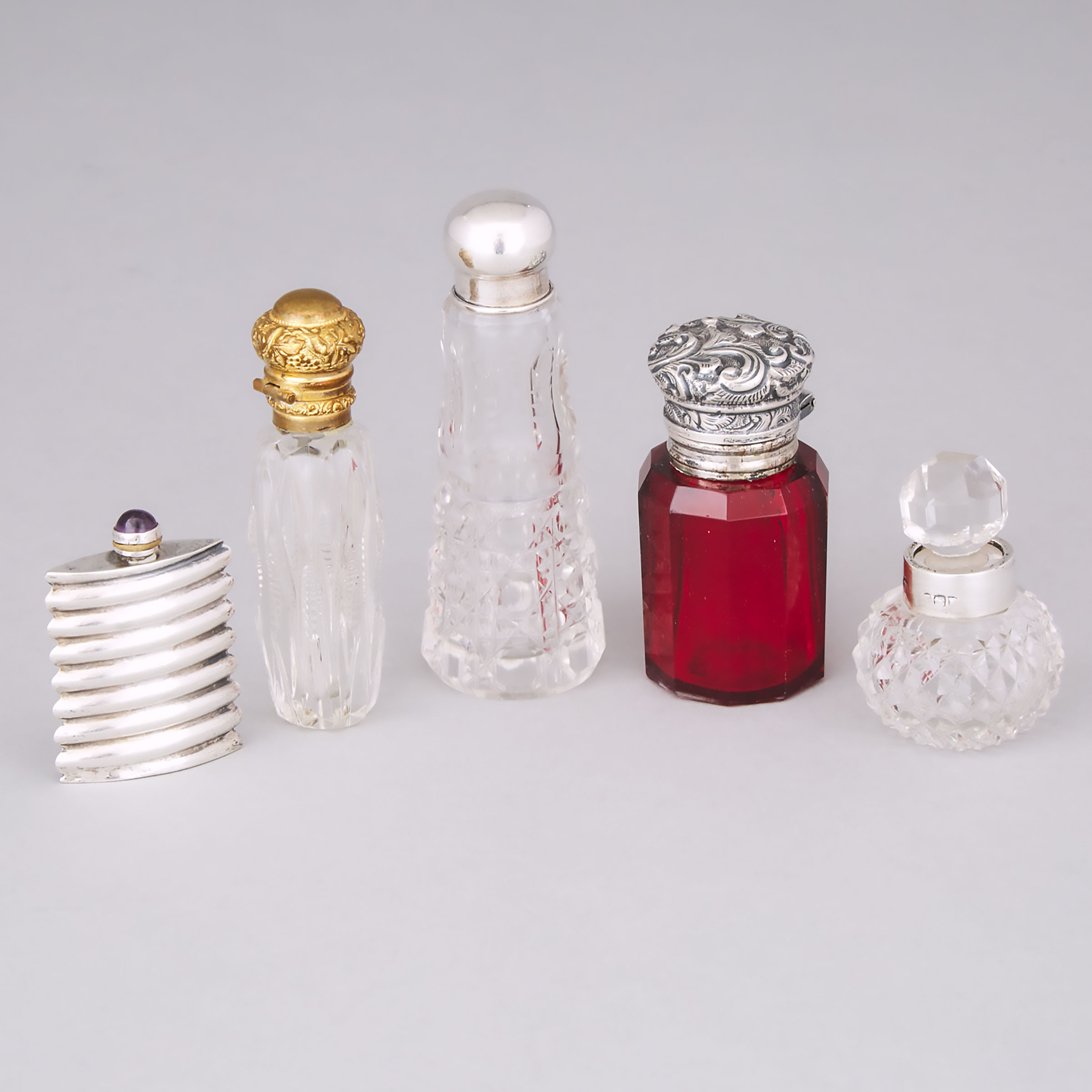 Five Silver and Metal Mounted Cut Glass Perfume Bottles, late 19th/early 20th century