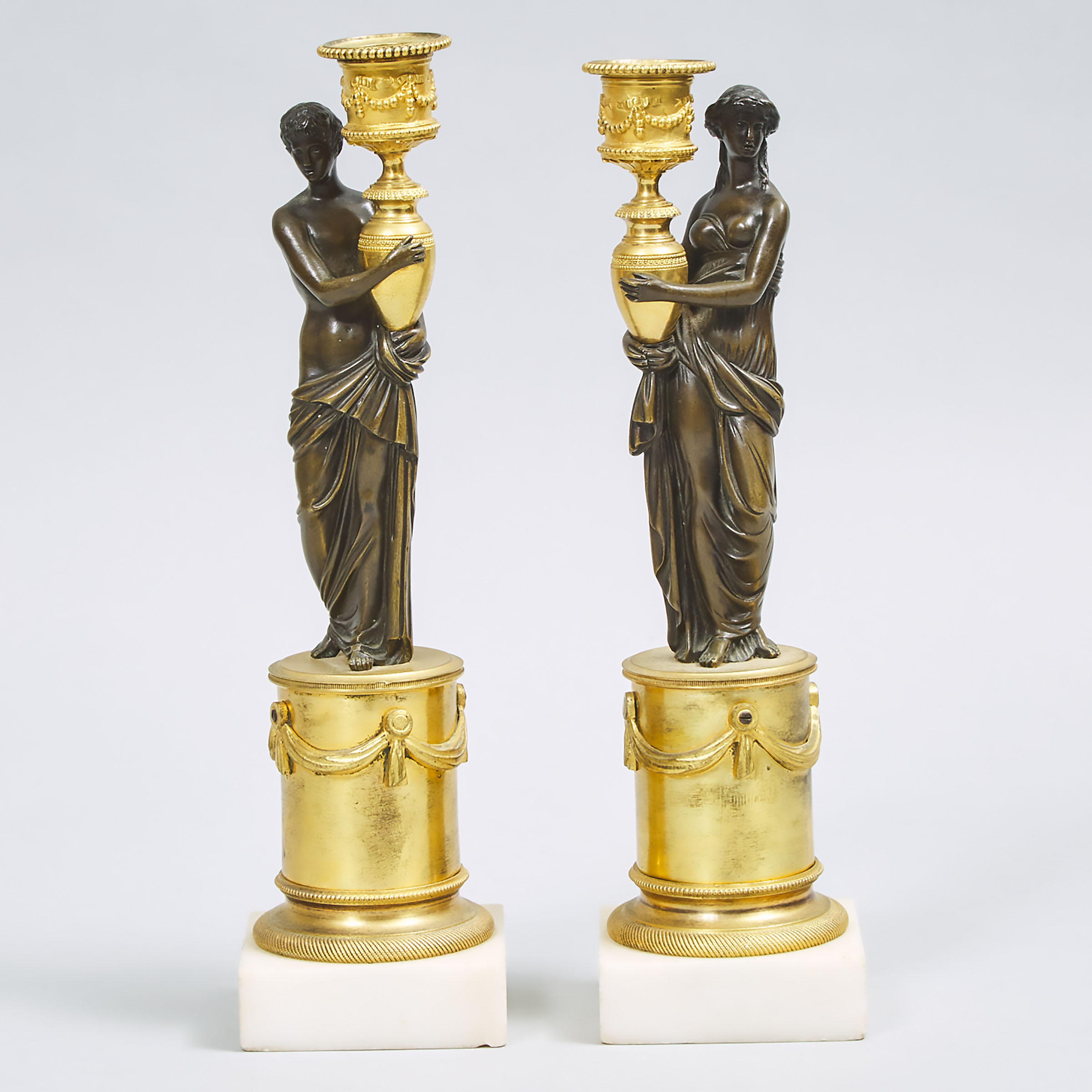 Pair of French Empire Style Gilt and Patinated Bronze Figural Candlesticks, eary 20th century