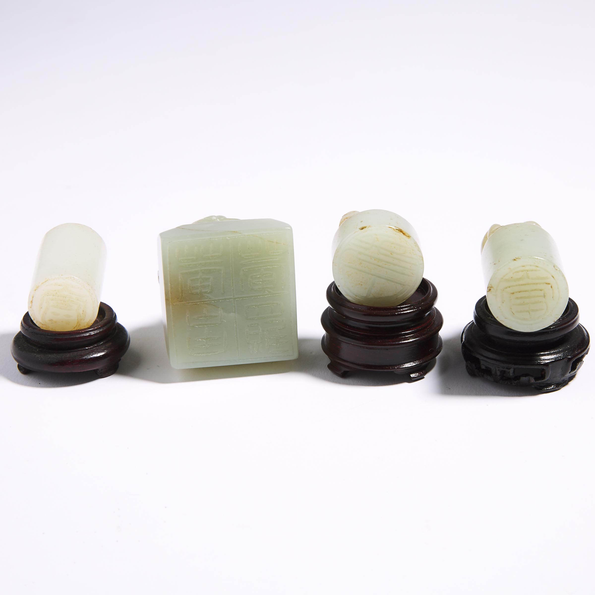 A Group of Four Celadon Jade Carved Seals