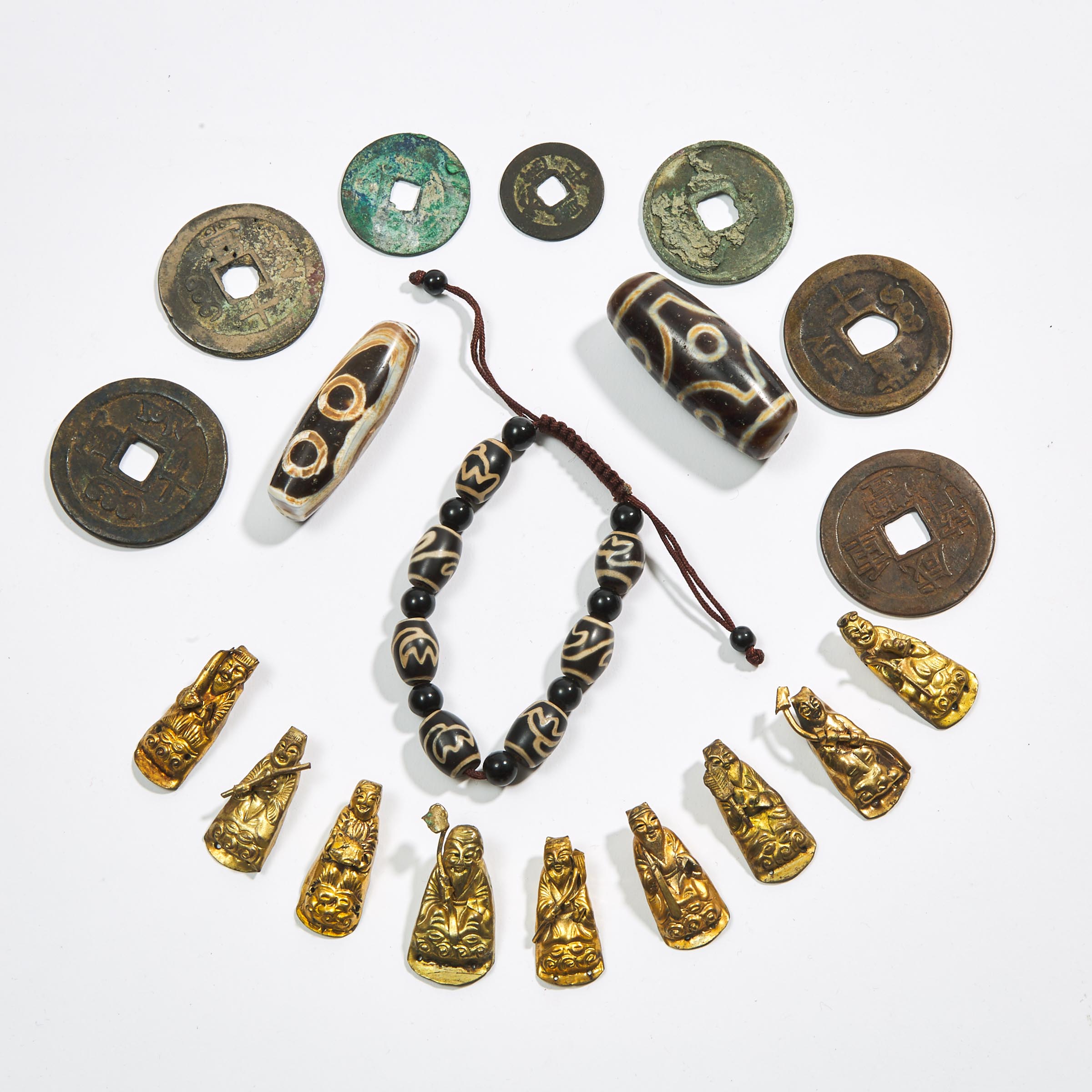 A Group of Nineteen Dzi Beads, Daoist Figure Fittings, and Coins