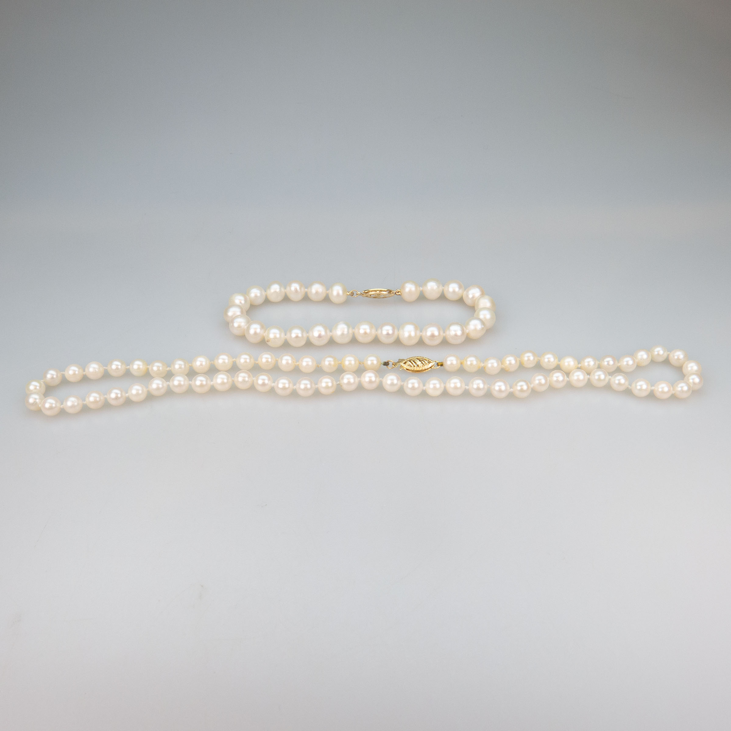 A Single Strand Of Cultured Pearls (5.5mm to 6.0mm) And A Freshwater Pearl Bracelet