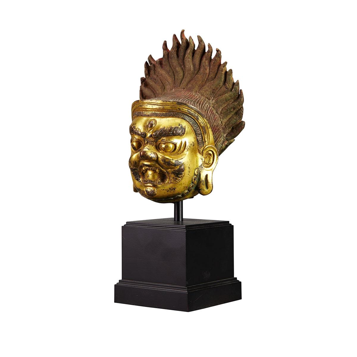 Large Gilt Bronze Head of a Guardian, Tibet, 18th Century