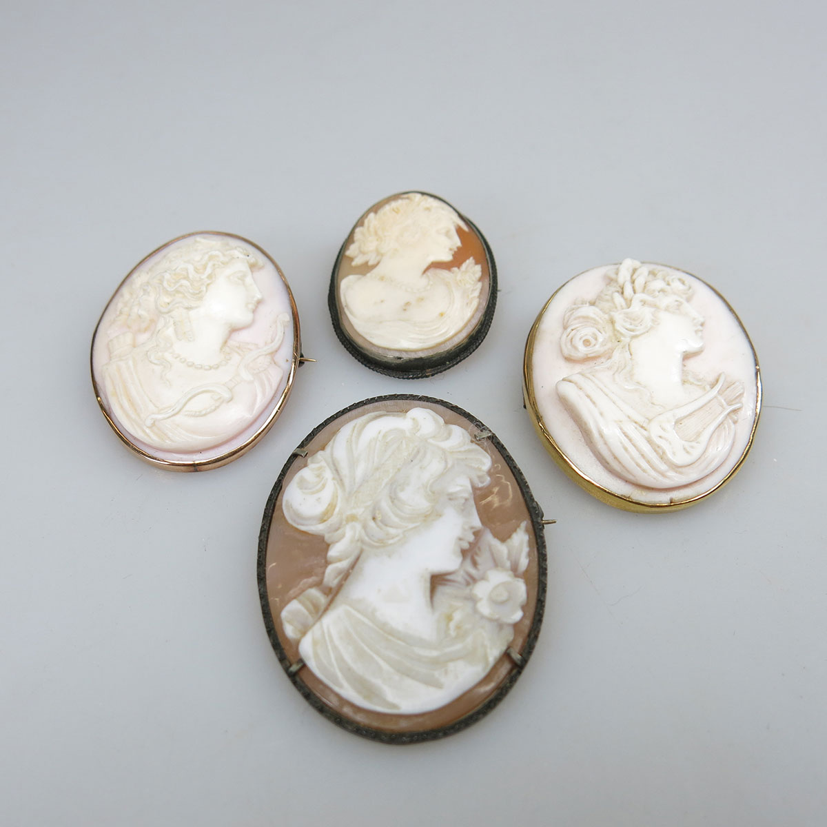 Four Carved Oval Shell And Pink Shell Cameos