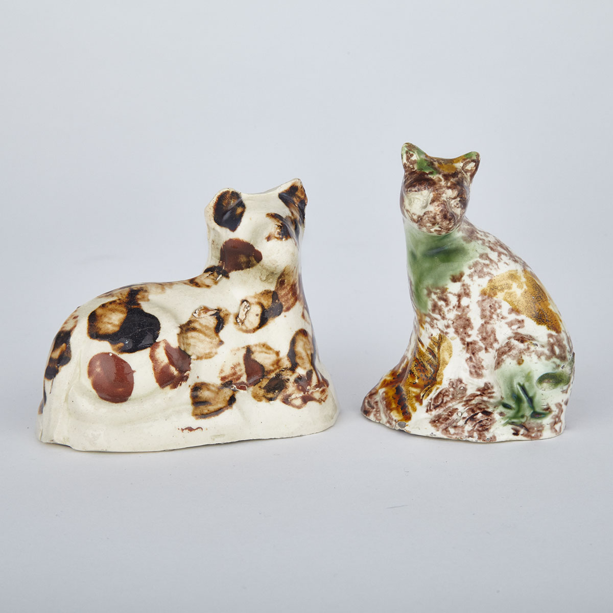 Bovey Tracey Creamware Model of a Cat and a Staffordshire Whieldon-Type Cat, late 18th century