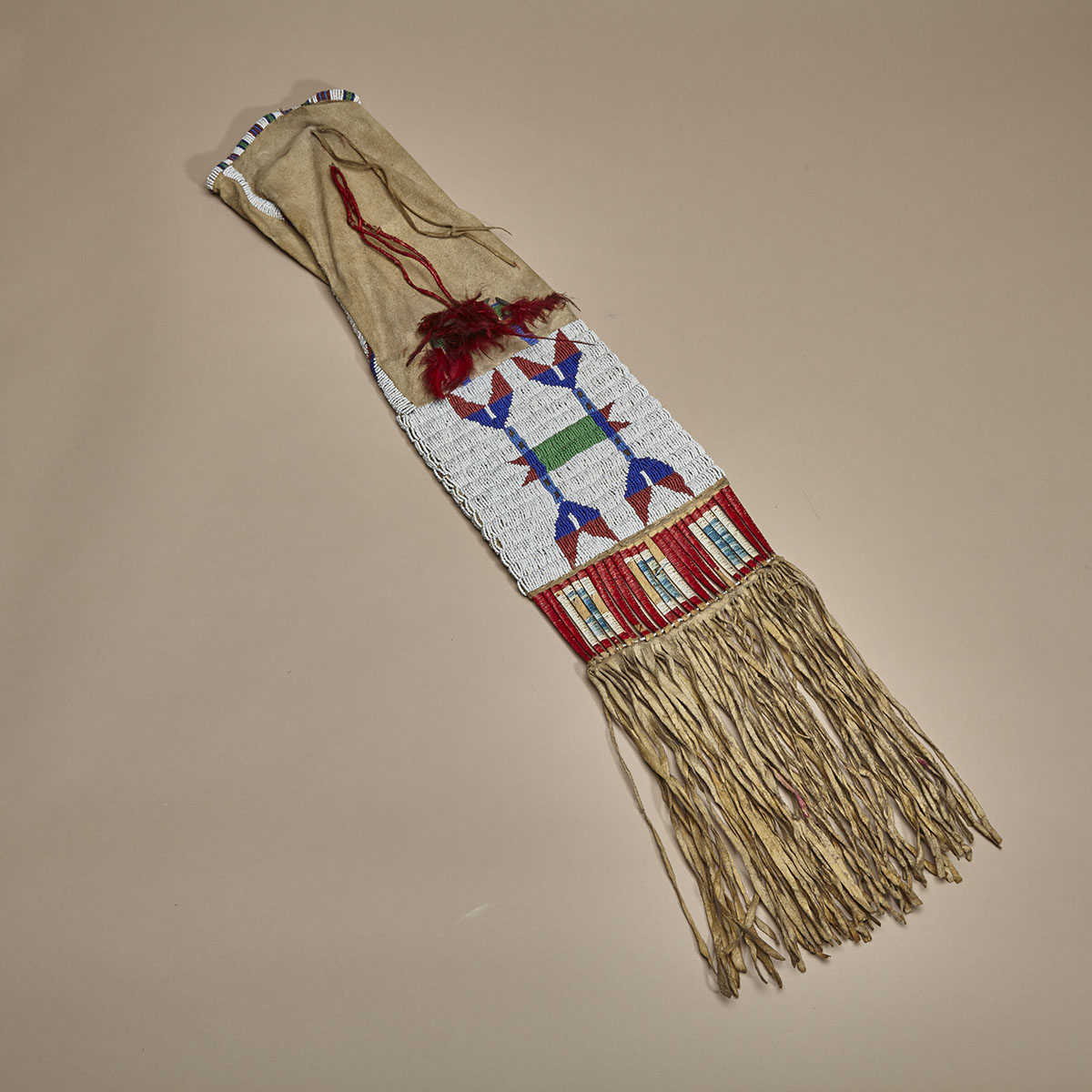 CENTRAL PLAINS PIPE BAG DECORATED WITH SEED BEADS AND PORCUPINE QUILL, BELLS AND DYED FEATHERS