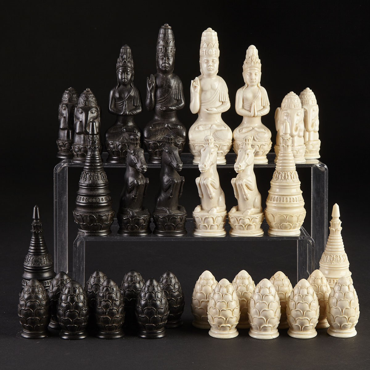 Burmese Buddhist Carved Ebony and Ivory Figural Chess Set, 19th century