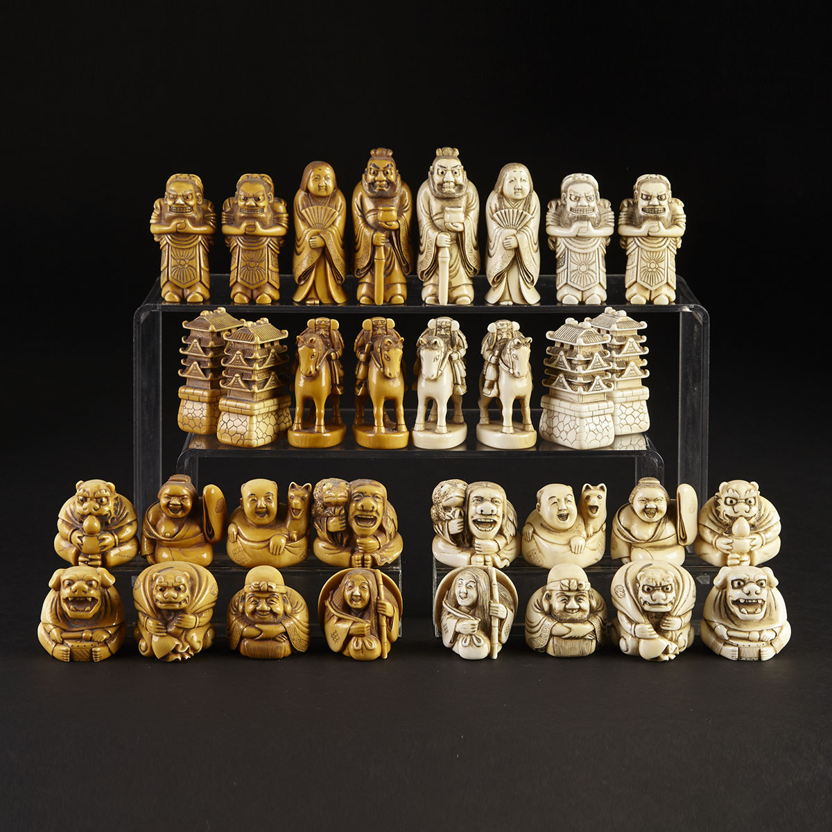 Japanese Carved Ivory Netsuke Type Figural Chess Set signed Tomomitsu, 19th or early 20th century