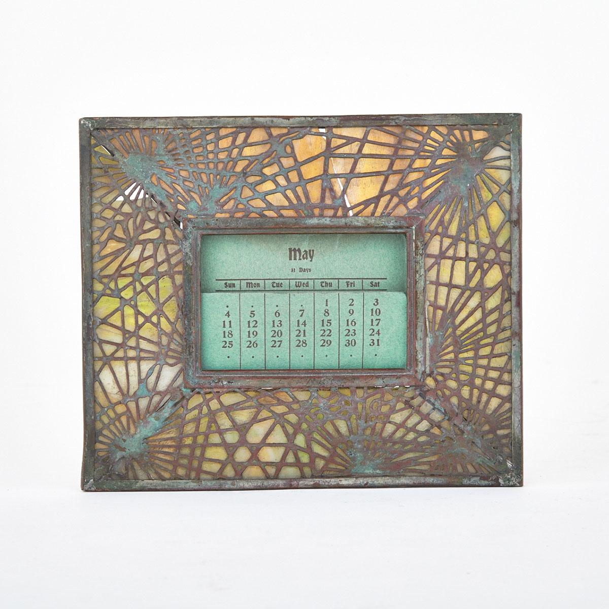 Tiffany Studios, New York, Patinated Bronze and Slag Glass ‘Pine Needle’ Pattern Desk Calendar, c.1910