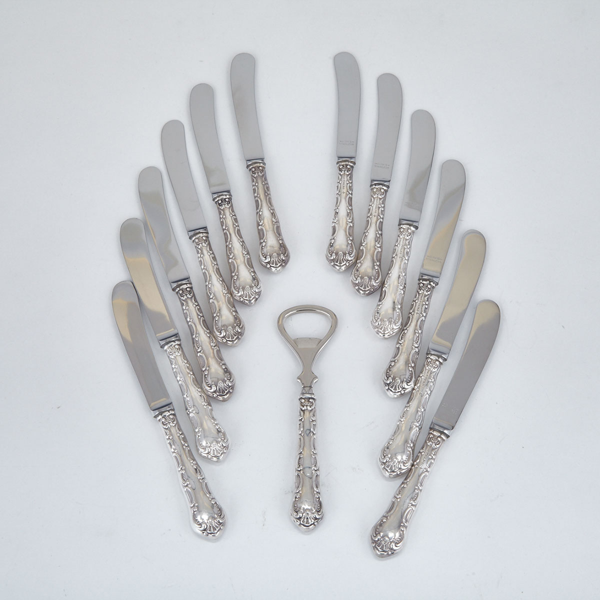 Twelve Canadian Silver ‘Pompadour’ Pattern Tea Knives and a Bottle Opener, Henry Birks & Sons, Montreal. Que., 20th century