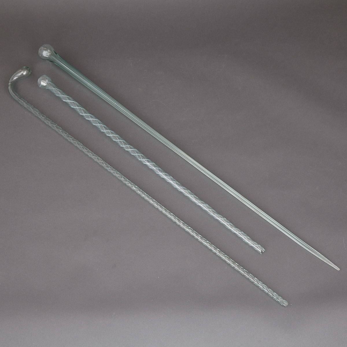 Three ‘End-of-Day’ Hollow Glass Parade Canes, 19th century