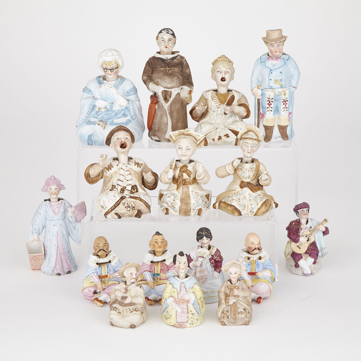 Sixteen Continental Bisque and Glazed  Porcelain Nodder Figures, late 19th/early 20th century