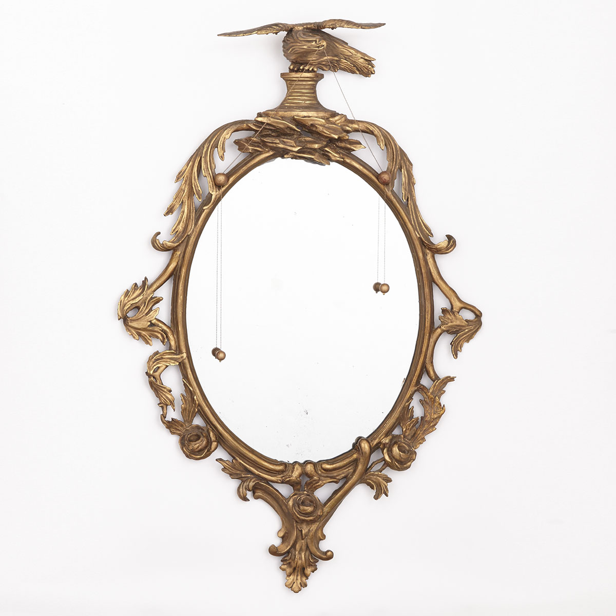 George III Oval Giltwood Mirror with Eagle Crest, early 19th century