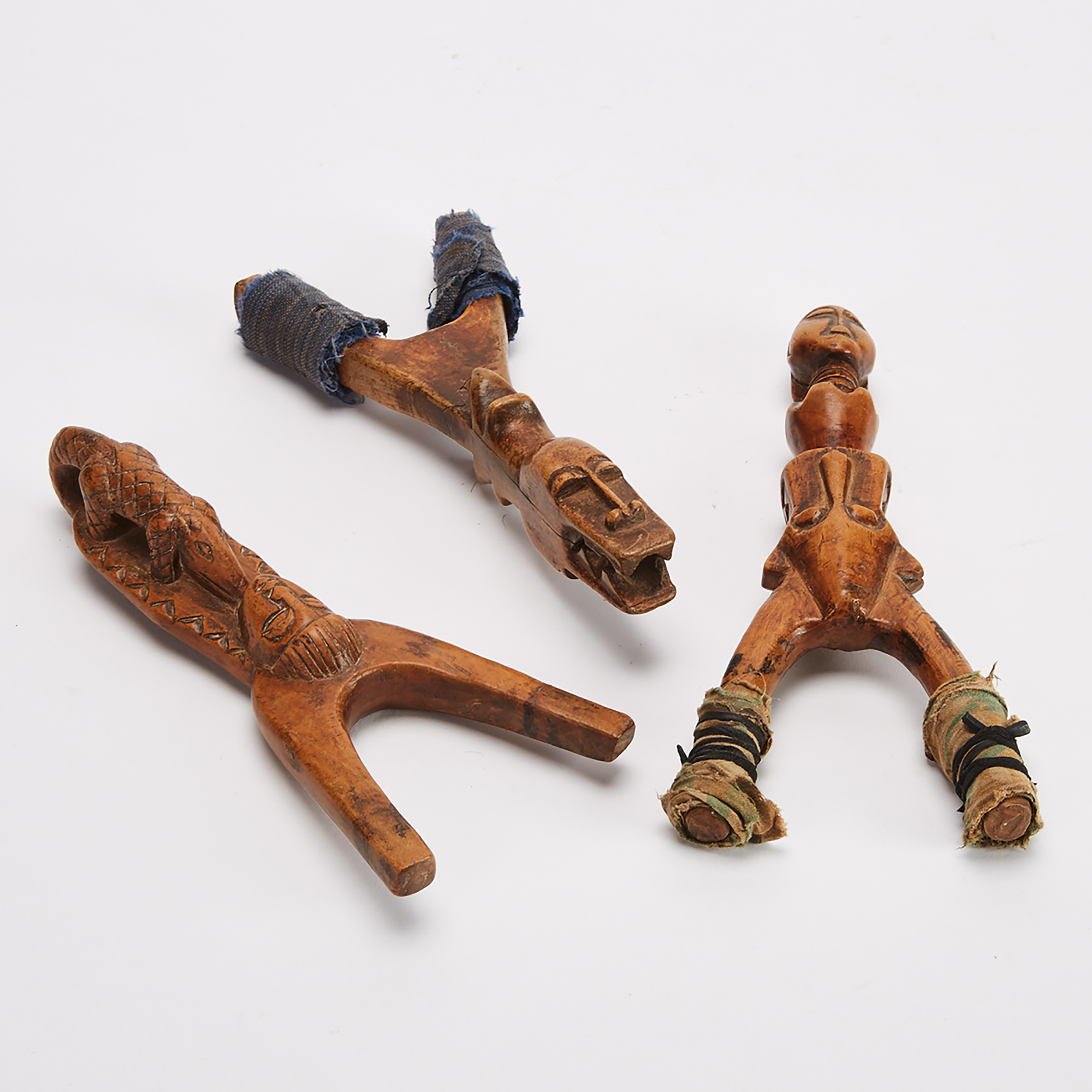 Two Baule Slingshots, Ivory Coast, West Africa together with a unidentified African slingshot