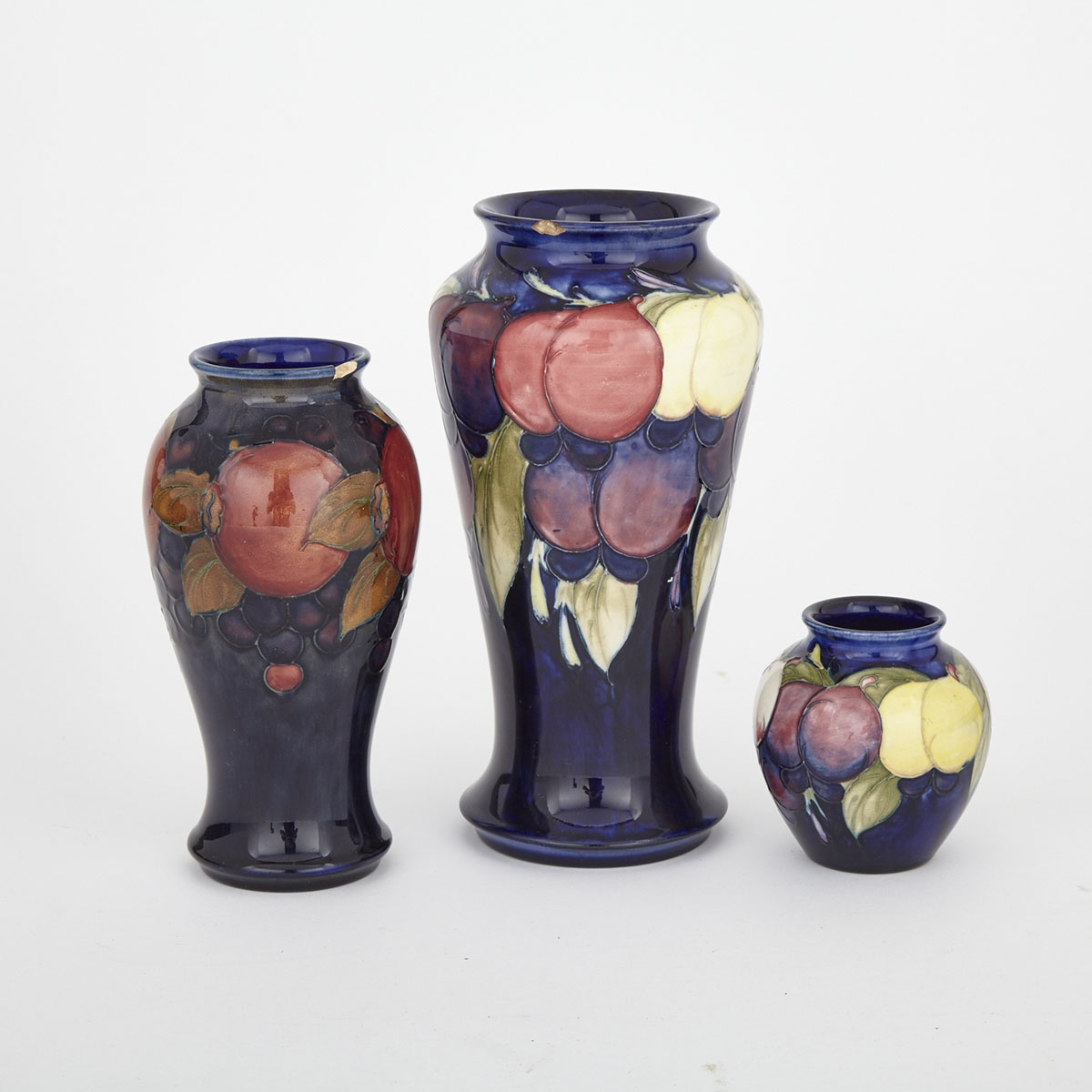 Two Moorcroft Wisteria Vases and a Pomegranate Vase, c.1925
