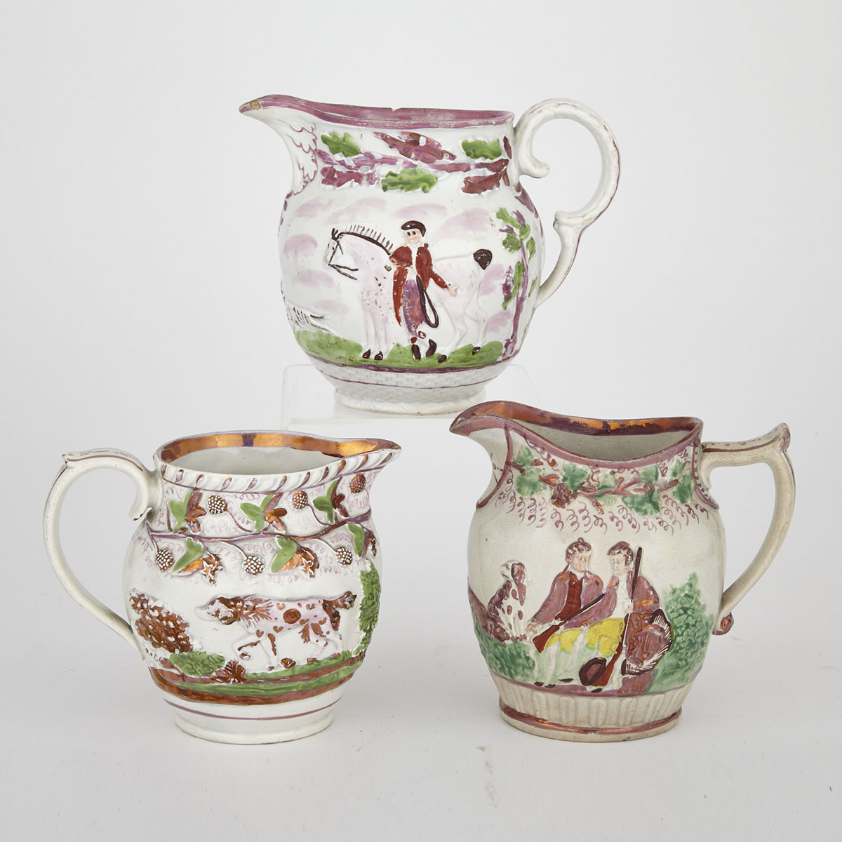 Three Staffordshire Moulded and Pink Lustre Decorated Jugs, 19th century