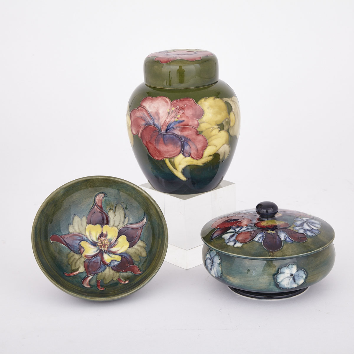 Moorcroft Orchids Covered Jar, Hibiscus Ginger Jar and Cover and a Columbine Bowl, 20th century